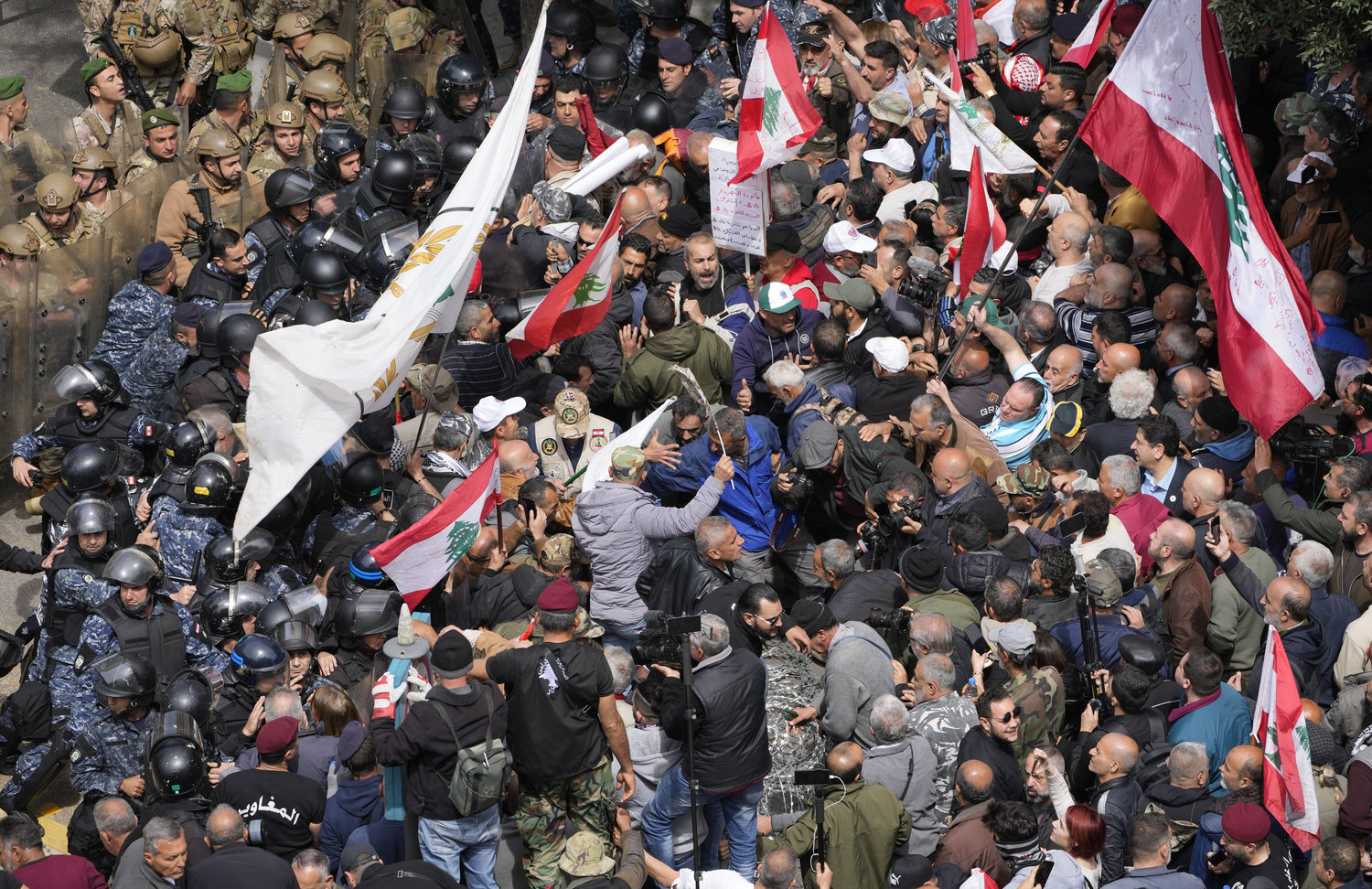 Retired army soldiers and other protesters, who are demanding better pay, clash with Lebanese army and riot police, in Beirut, Lebanon, Wednesday, March 22, 2023. (AP Photo/Hussein Malla)