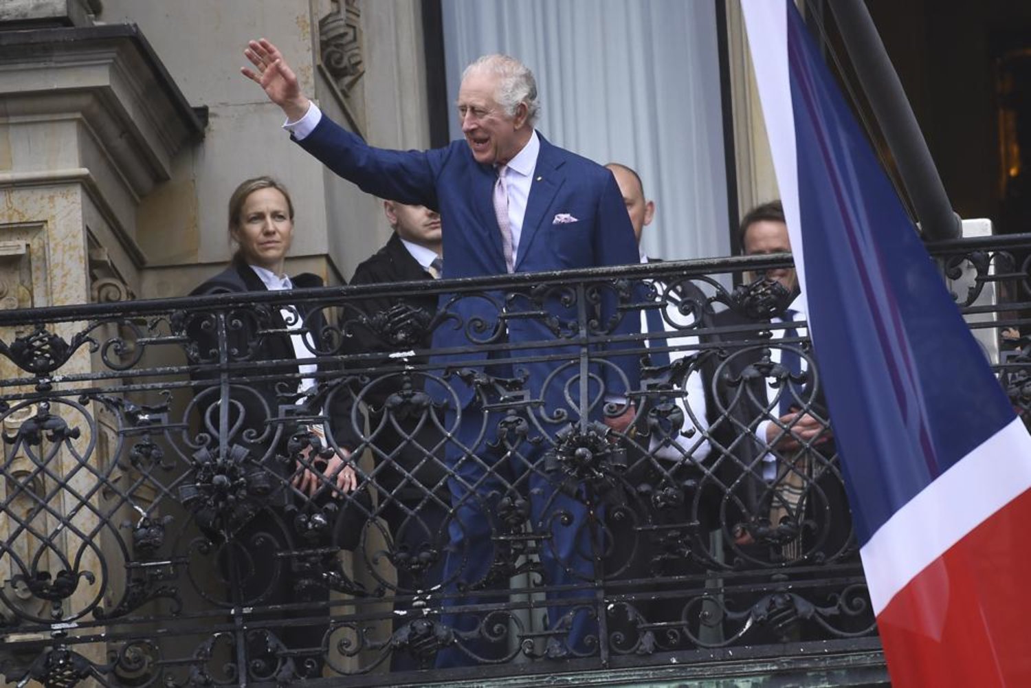 FILE - Britain's King Charles III waves from a balcony of the city hall in Hamburg, Germany, Friday, March 31, 2023. (AP Photo/Gregor Fischer, File)
