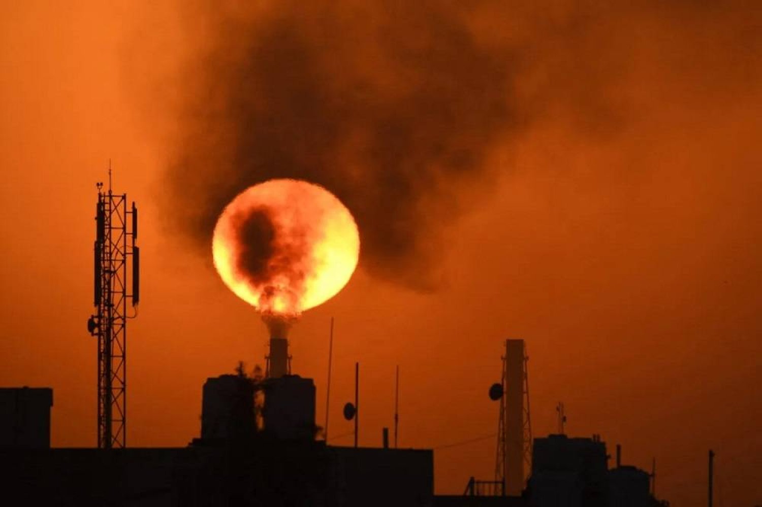 The sun sets over an oil refinery in the southern Iraqi town of Nasiriyah on March 8, 2021. (AFP via Getty Images) 