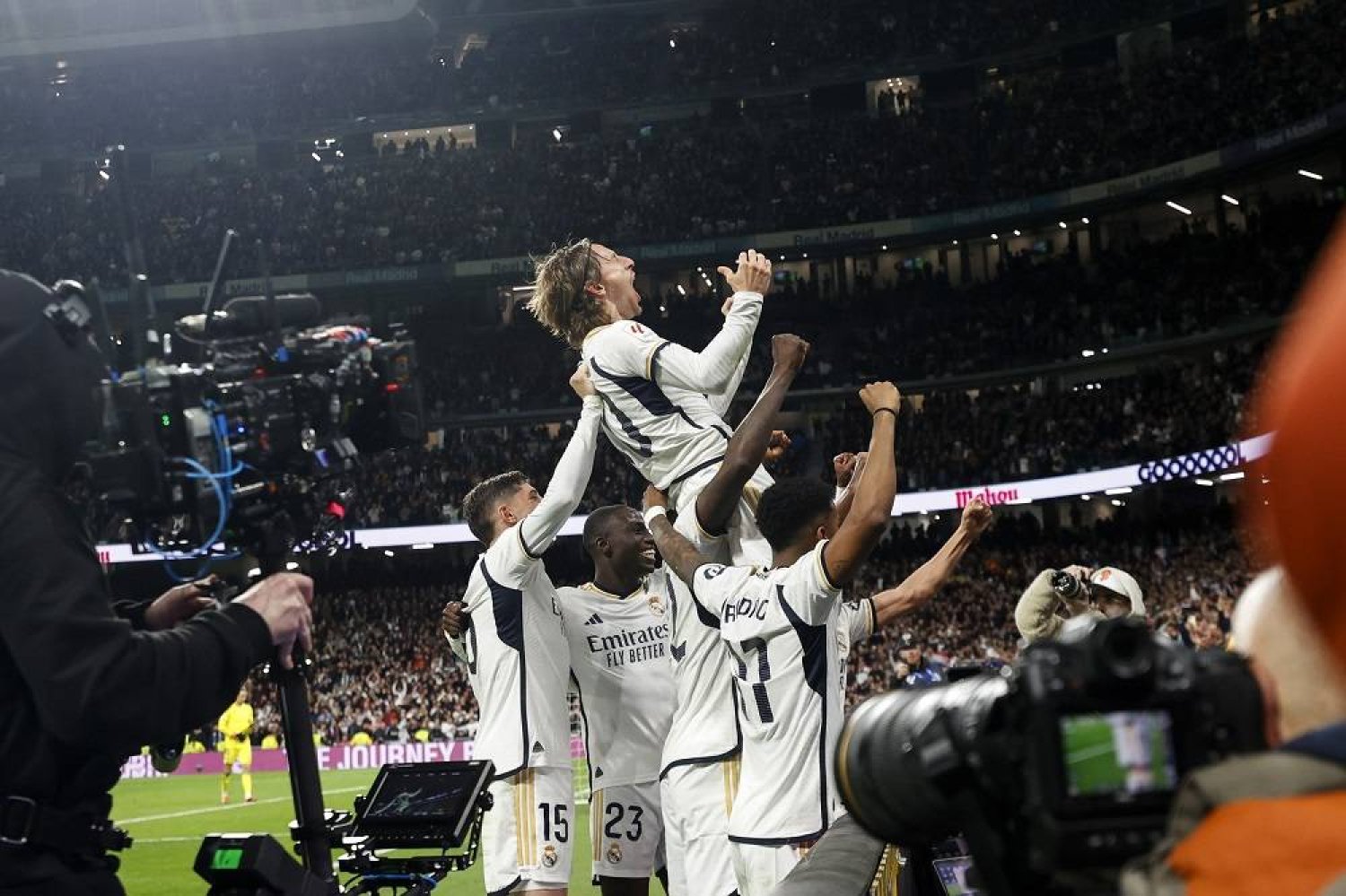 Real Madrid's Luka Modric (C) celebrates with his teammtaes after scoring the 1-0 goal during the Spanish LaLiga soccer match between Real Madrid and Sevilla FC in Madrid, Spain, 25 February 2024. (EPA)