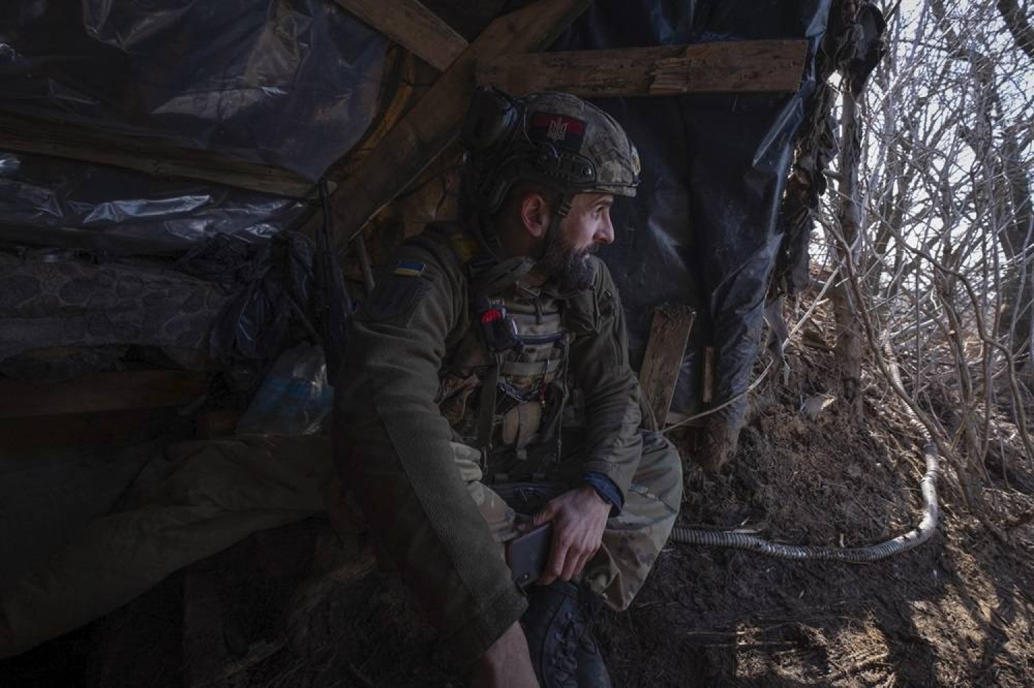  A Ukrainian soldier looks out of a shelter at the frontline in the Donetsk region, Ukraine, Sunday, Feb. 25, 2024. (AP)