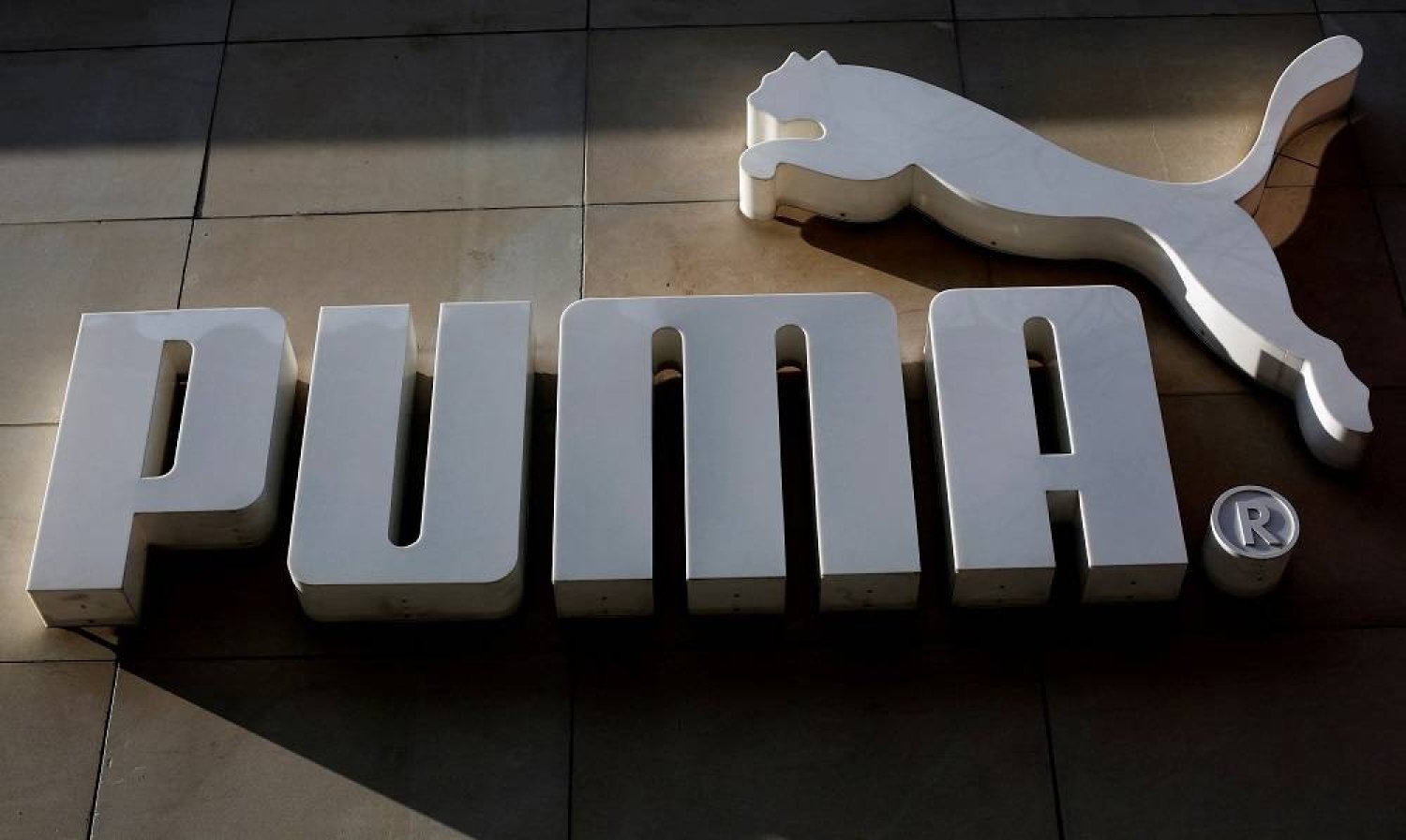 The logo of German sports goods firm Puma is seen at the entrance of one of its stores in Vienna, Austria, March 18, 2016. (Reuters)