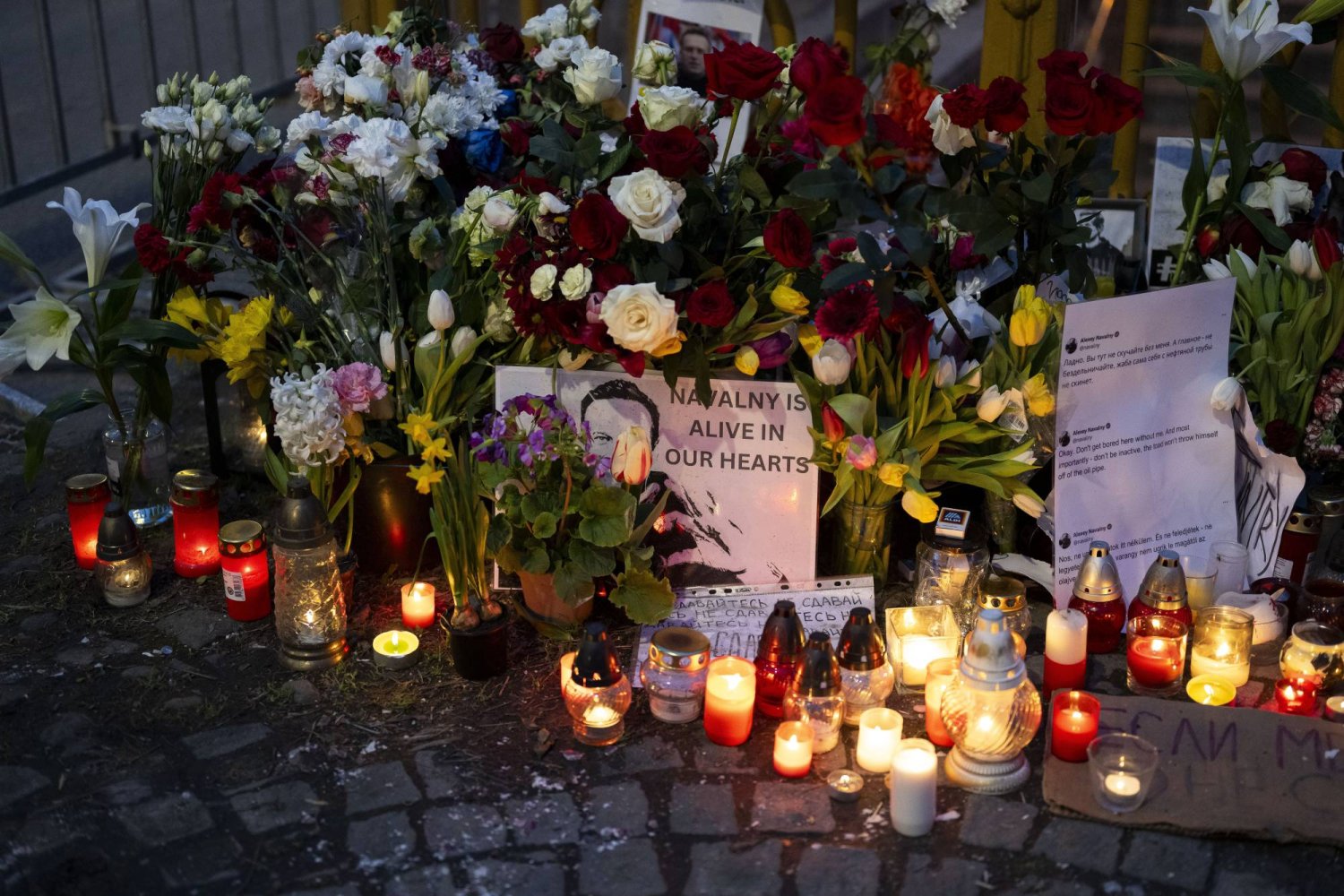 Flower and a pictures are left as a tribute to Russian opposition leader Alexei Navalny, near to the Russian Embassy in Budapest, Hungary, Saturday, Feb. 24, 2024. (AP Photo/Denes Erdos)