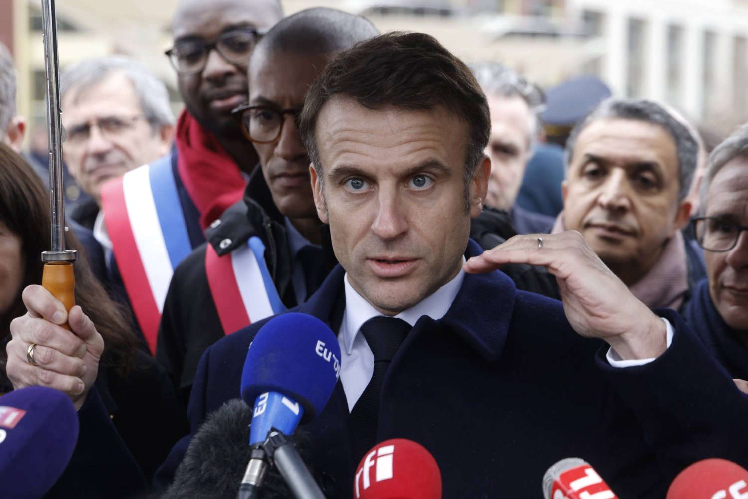 France's President Emmanuel Macron, surrounded by officials, attends the inauguration ceremony of the Paris 2024 Olympic village in Saint-Denis, north of Paris, Thursday, Feb. 29, 2024. (Ludovic Marin, Pool via AP)