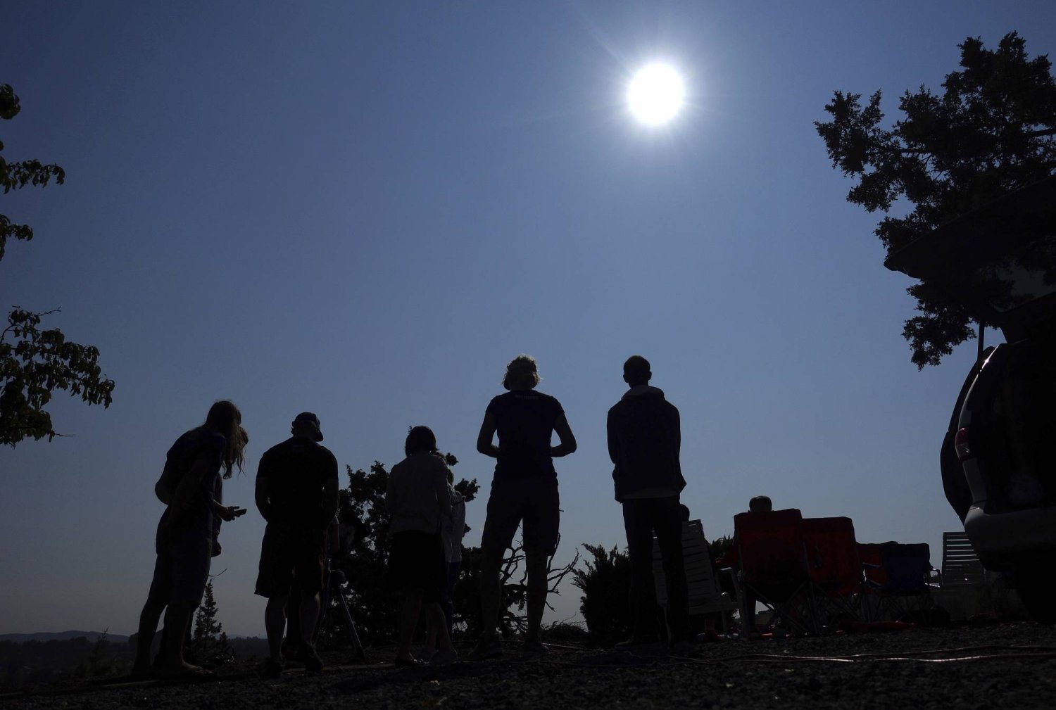 FILE - People gather near Redmond, Ore., to view the sun as it nears a total eclipse by the moon, Monday, Aug. 21, 2017. (AP Photo/Ted S. Warren, File)