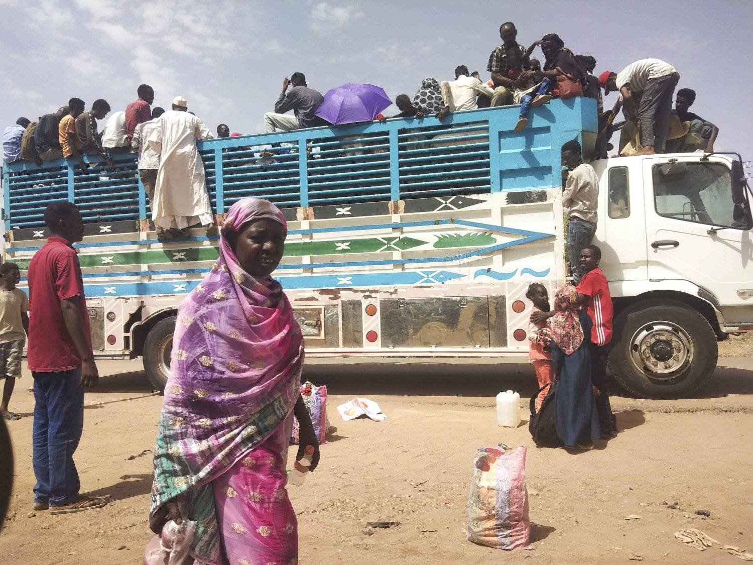 People are seen getting on a bus to leave Khartoum, Sudan. (AP)