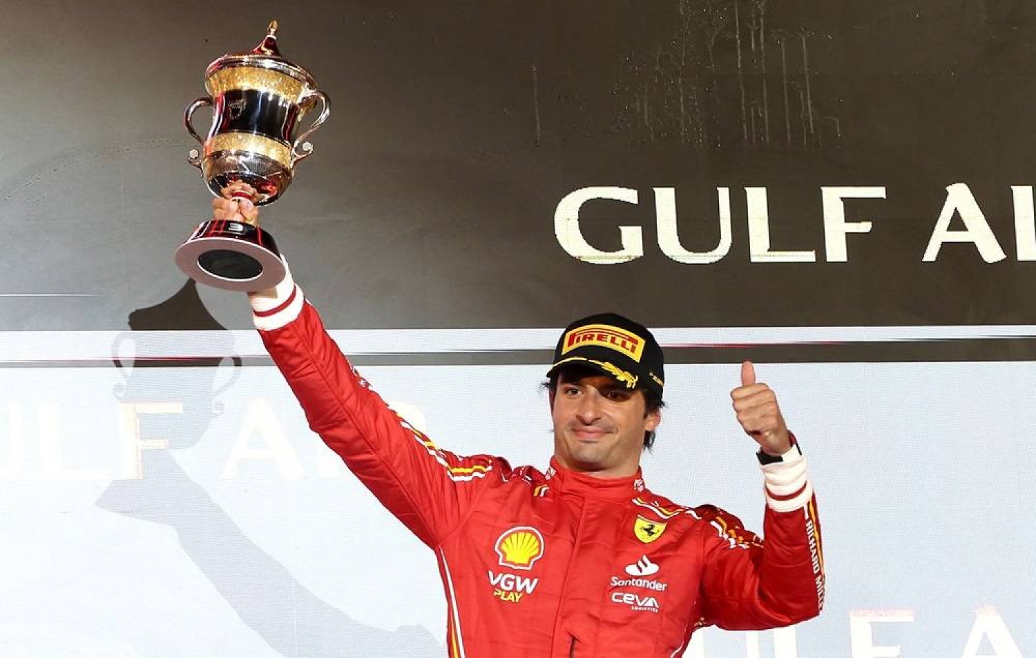 Third placed Scuderia Ferrari driver Carlos Sainz Jr. of Spain lifts his trophy on the podium during the victory ceremony of the Formula One Bahrain Grand Prix, at Bahrain International Circuit in Sakhir, Bahrain, 02 March 2024. (EPA)