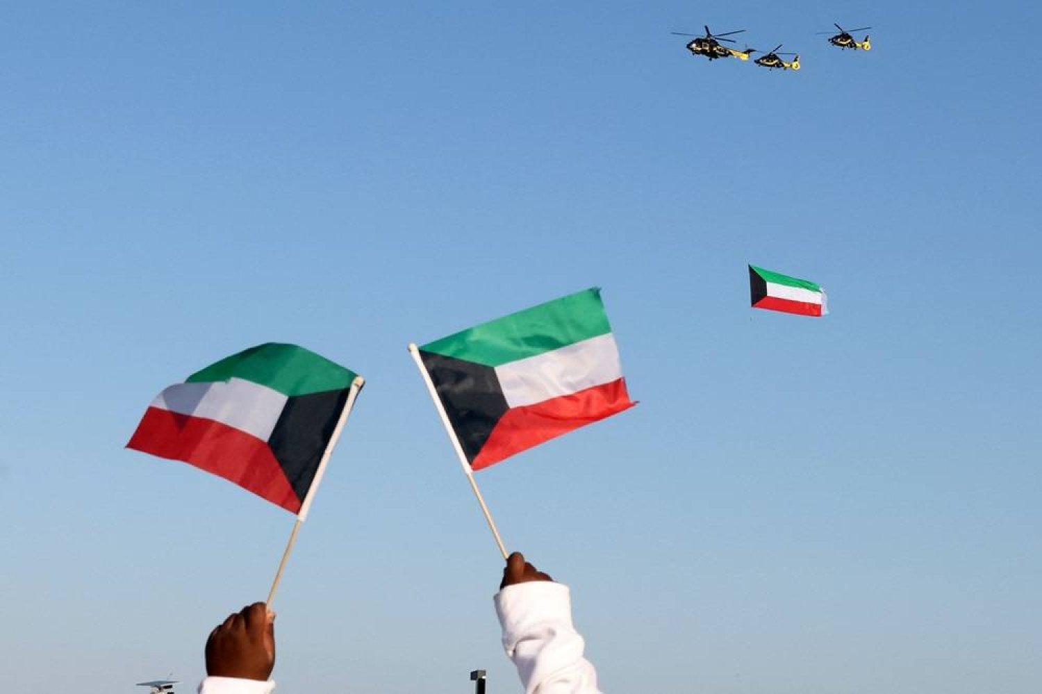  Kuwaiti military helicopters perform during an airshow to mark country's 63rd Independence Day celebrations in Kuwait City on February 26, 2024. (AFP)