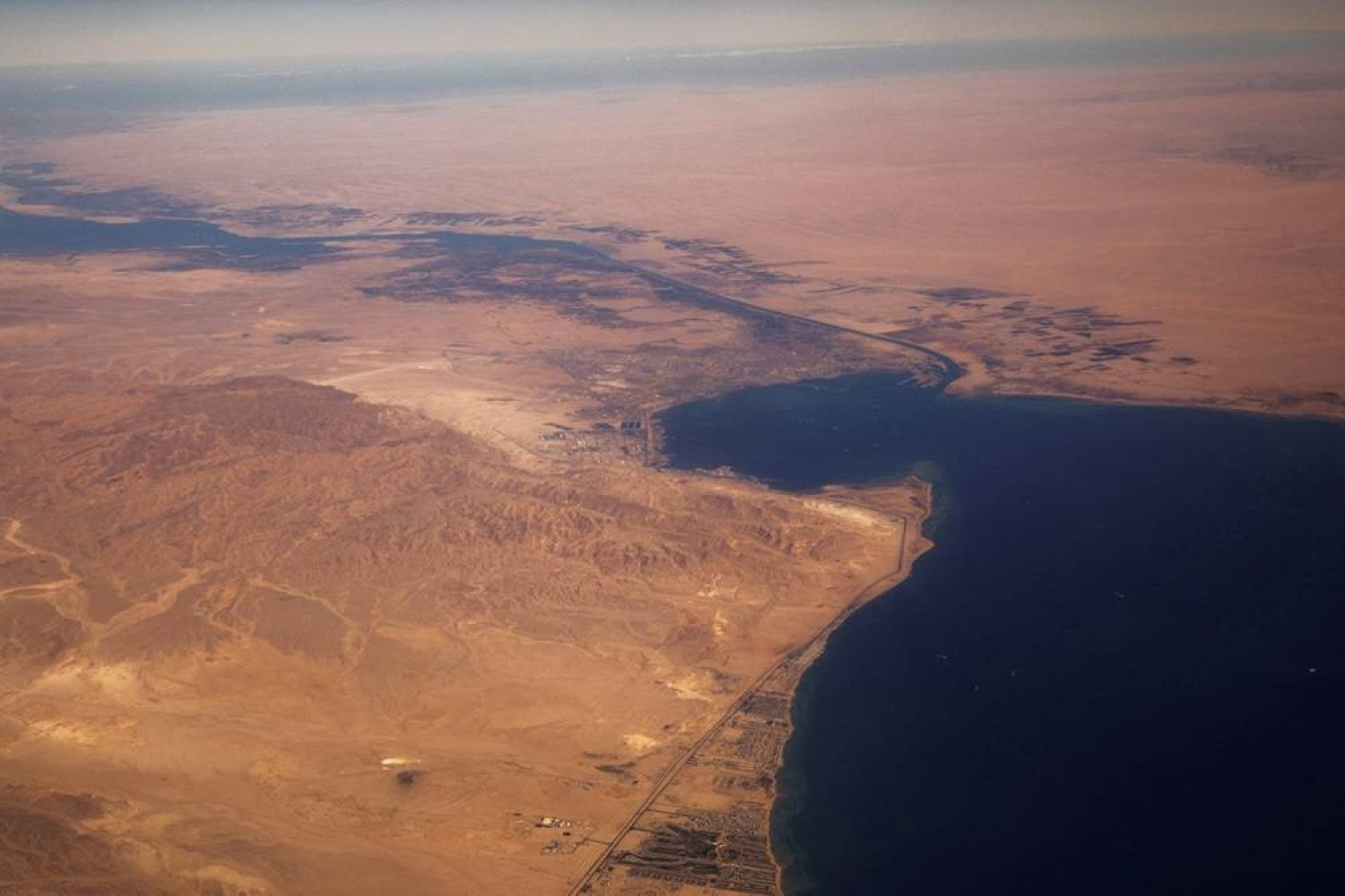 The Suez Canal connecting the Mediterranean Sea to the Red Sea is pictured from the window of a commercial plane flying over Egypt, December 18, 2019. (Reuters)