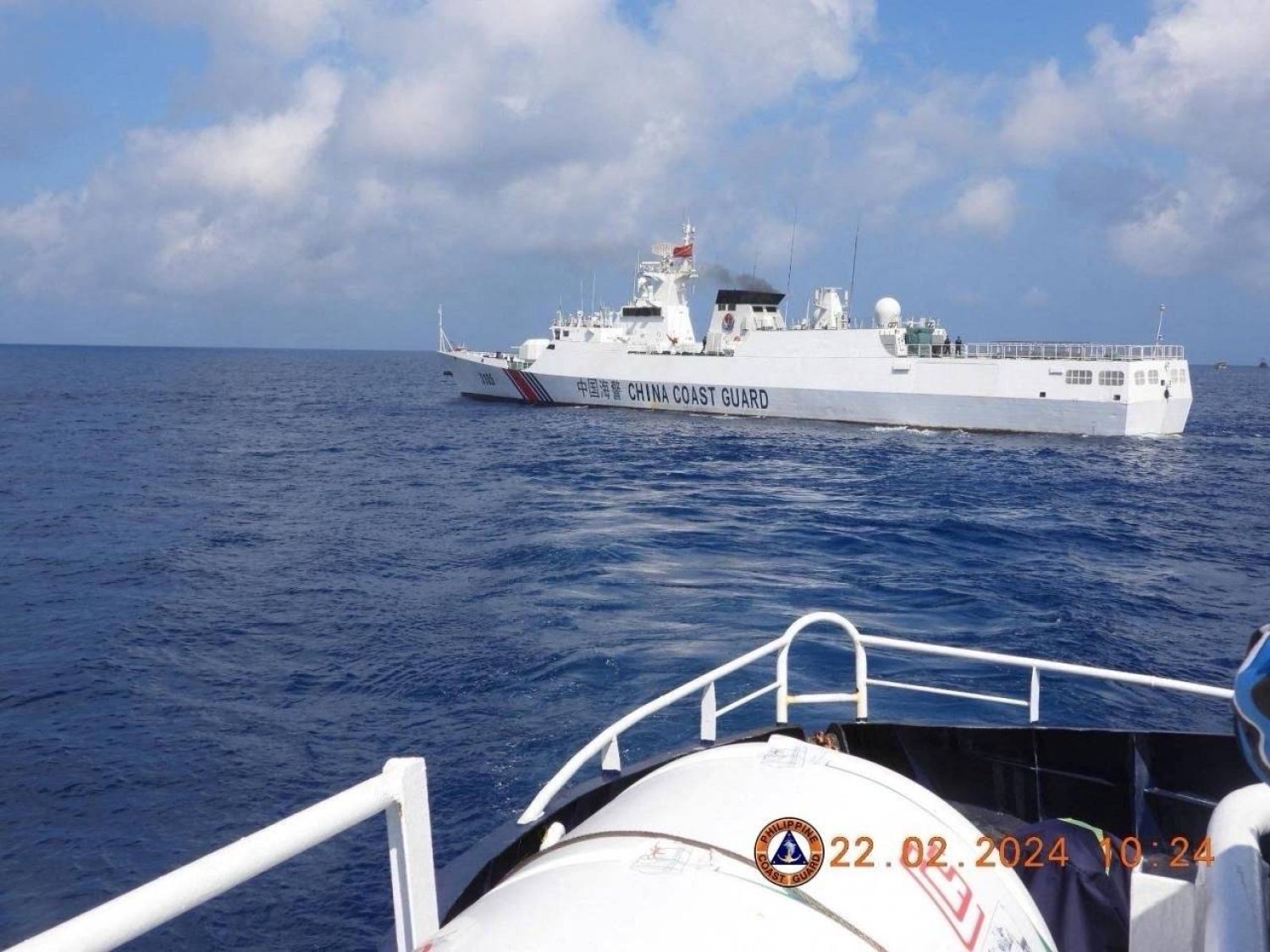 This handout photo taken on February 22, 2024 and received on February 25, 2024 from the Philippine Coast Guard shows a China Coast Guard vessel sailing near the BRP Datu Sanday during their mission to bring supplies to fishermen near the China-controlled Scarborough Shoal in the disputed South China Sea. (Photo by Handout / Philippine Coast Guard (PCG) / AFP) 