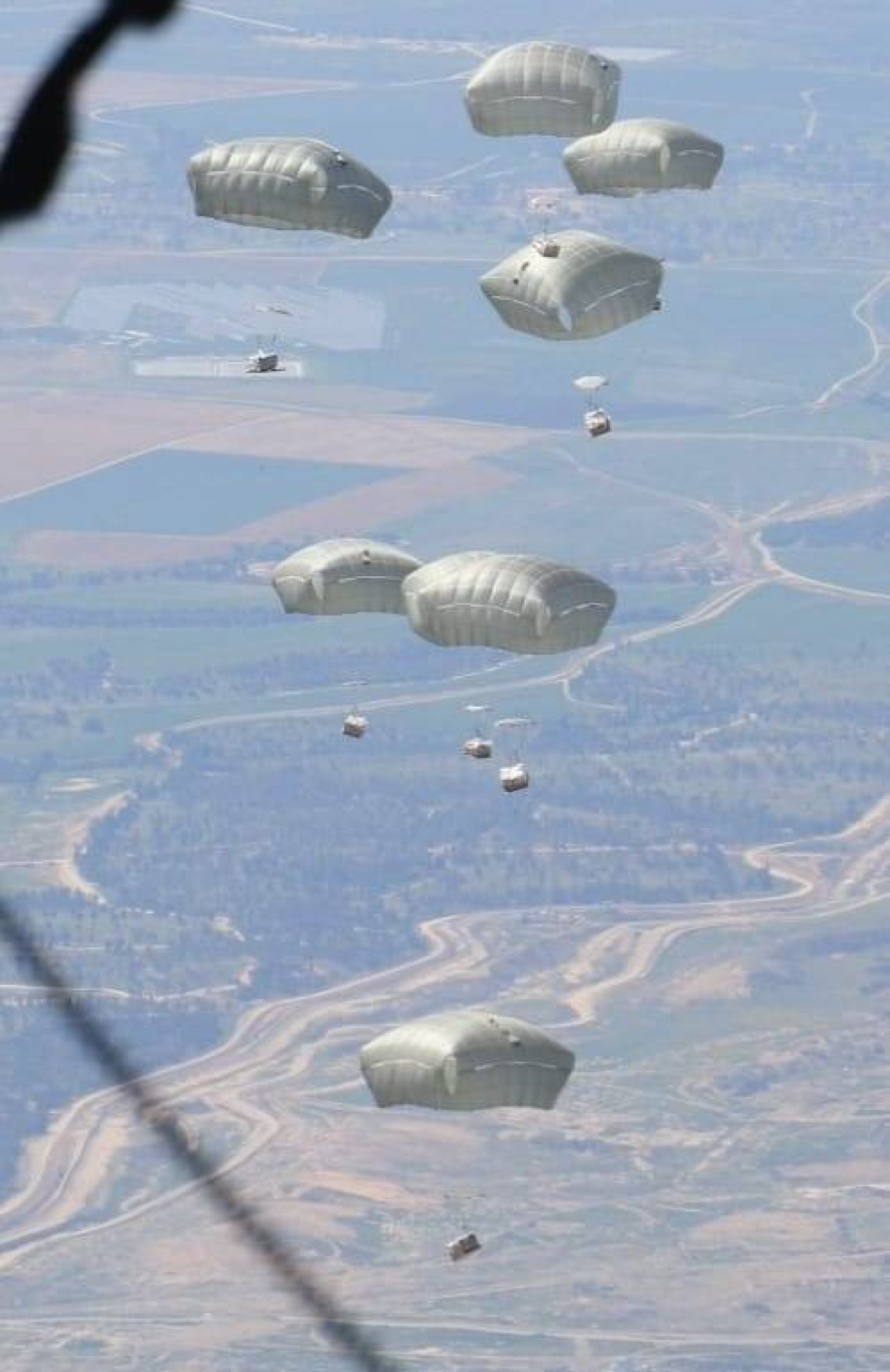 Jordanian Armed Forces members air drop aid parcels to several areas in northern Gaza, in this undated handout picture released on March 1, 2024. Jordanian Armed Forces/Handout via REUTERS 