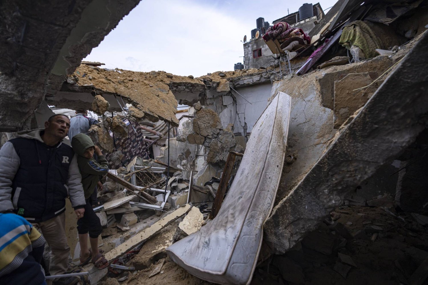 Palestinians inspect the damage to a house after an Israeli airstrike in Rafah, southern Gaza Strip, Tuesday, March 19, 2024. (AP Photo/Fatima Shbair)