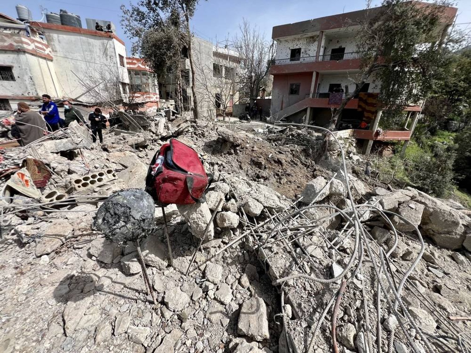 People inspect the damage at the site of an airstrike in Habbariyah, southern Lebanon, 27 March 2024. (EPA)