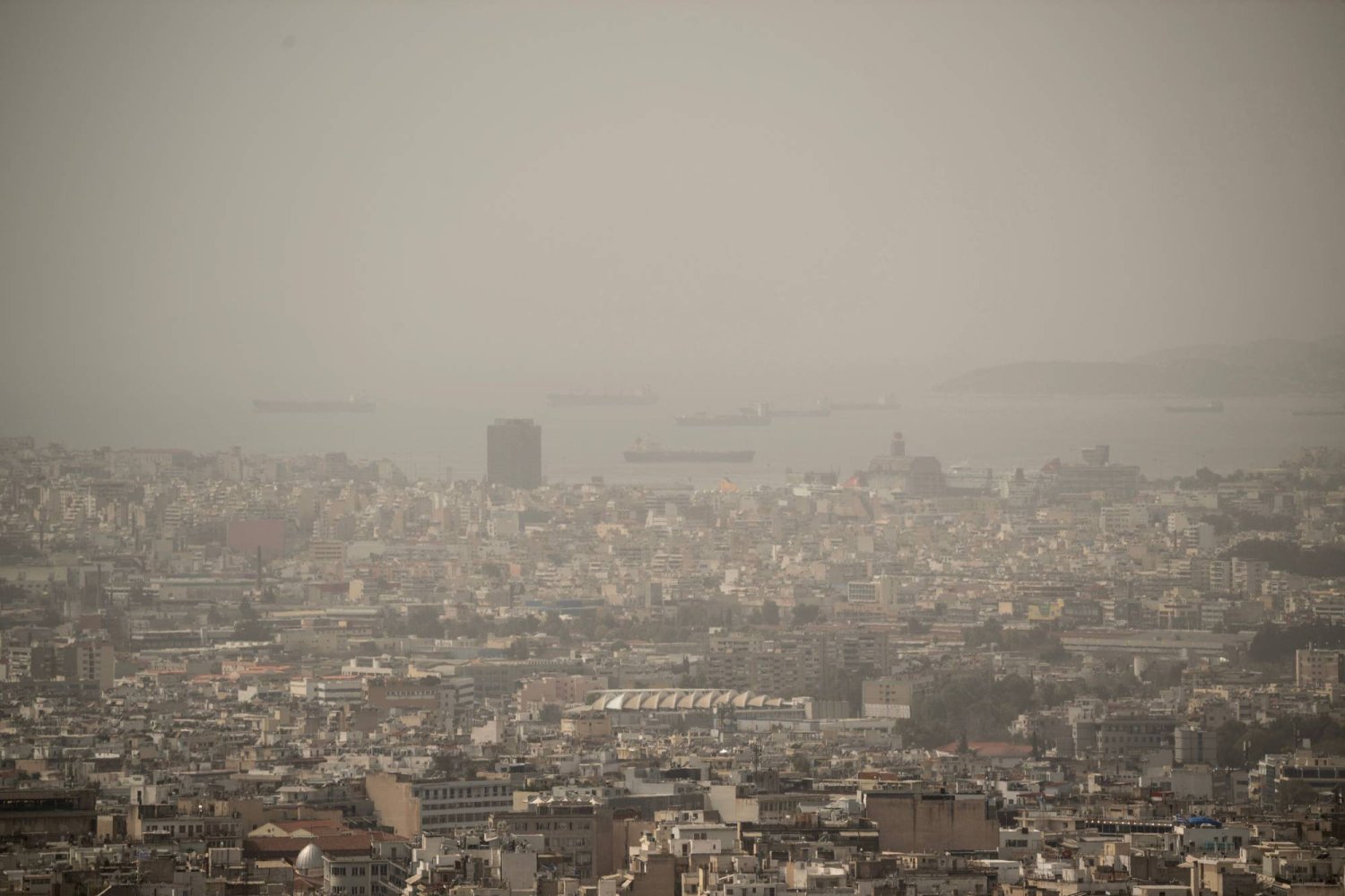 This photo taken on March 27, 2024 shows the city of Athens shrouded in haze. (Photo by Angelos TZORTZINIS / AFP)
