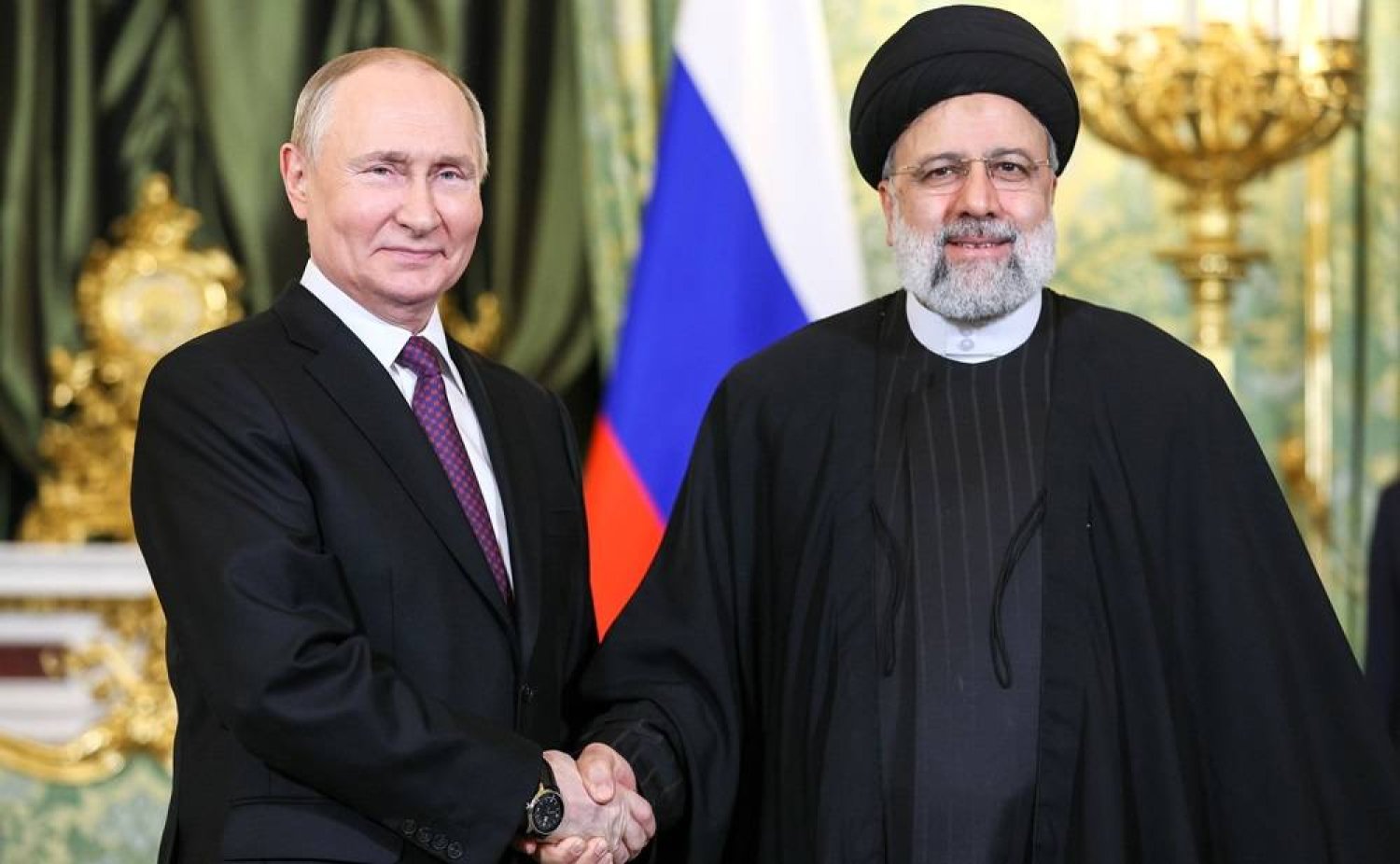 07 December 2023, Russia, Moscow: Russian President Vladimir Putin (L) shakes hands meets Iranian President Ebrahim Raisi (R) ahead of their meeting at Kremlin. Kremlin/dpa 
