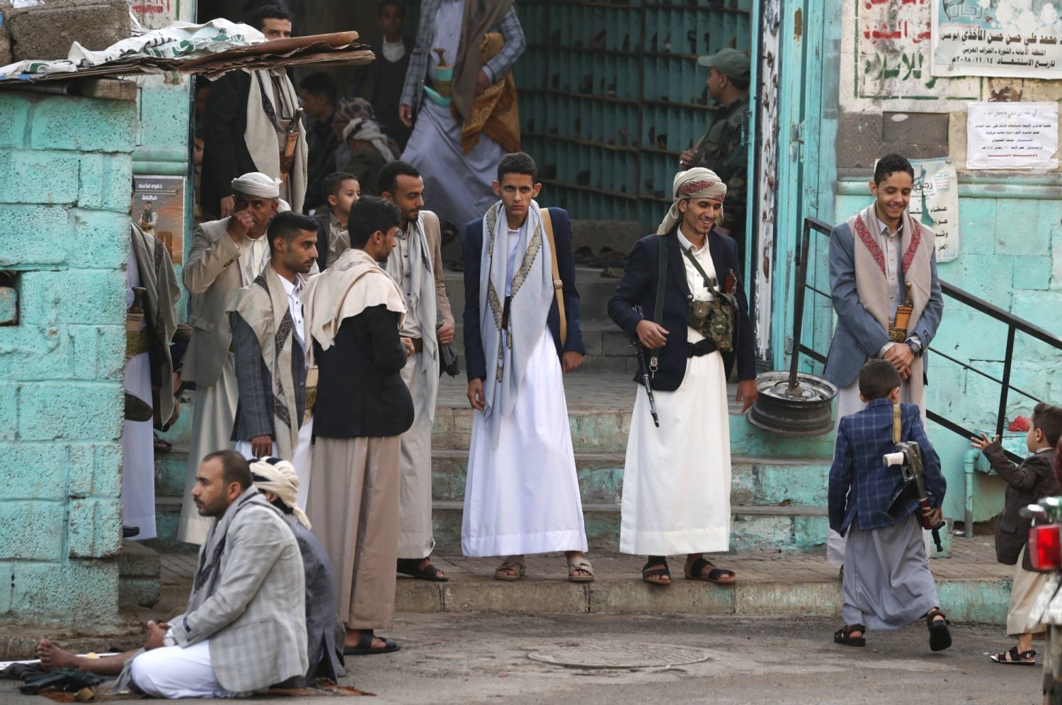 Armed Houthi fighters stand guard at the entrance to a mosque during Eid al-Fitr prayers in Sanaa, Yemen, 10 April 2024. EPA/YAHYA ARHAB
