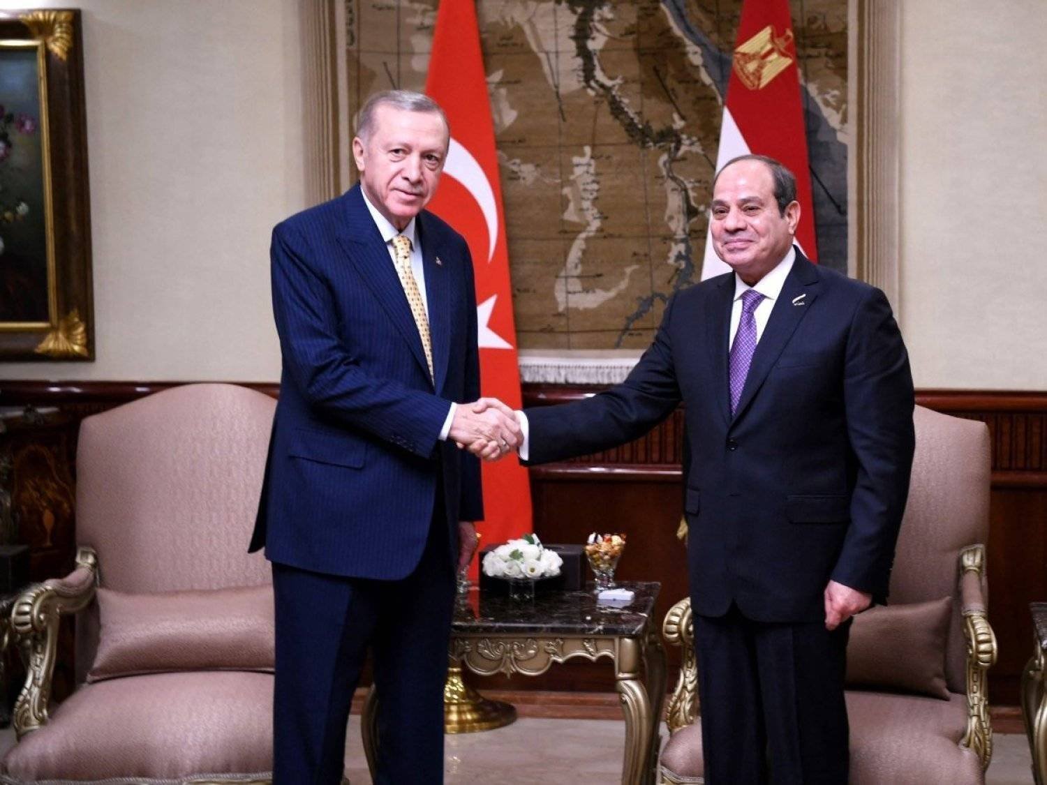 The Egyptian president shakes hands with his Turkish counterpart during his visit to Cairo last February (AFP)