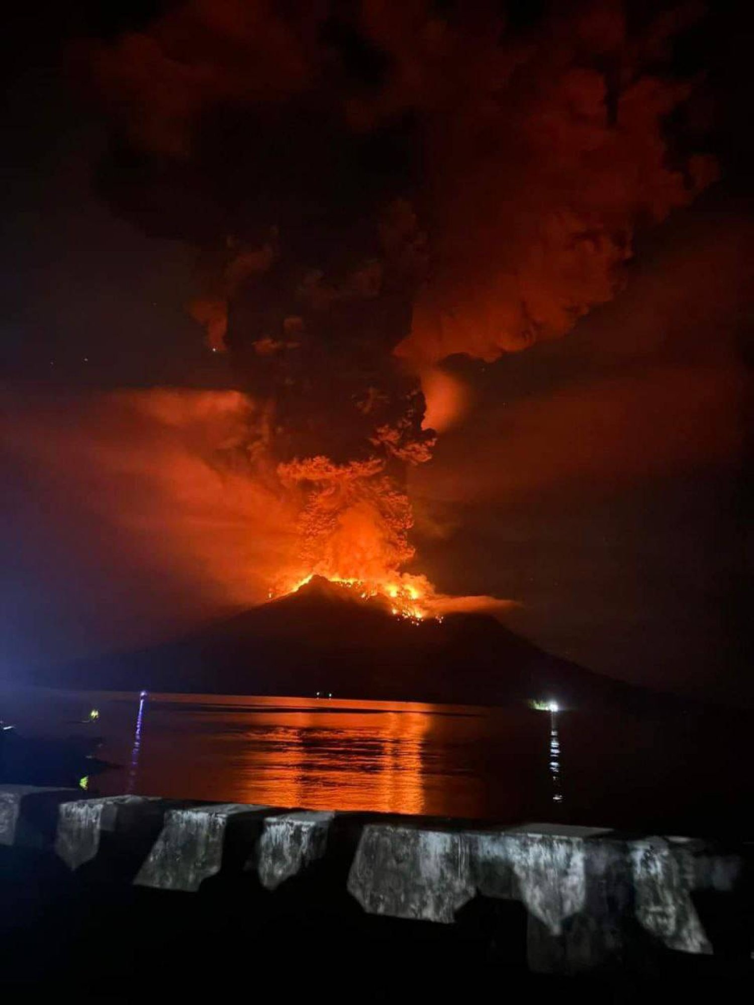 A handout photo made available by the Indonesian Center for Volcanology and Geological Hazard Mitigation shows smoke and lava erupting from Mount Ruang, as seen from Sitaro, Indonesia, 17 April 2024. EPA/PVMBG
