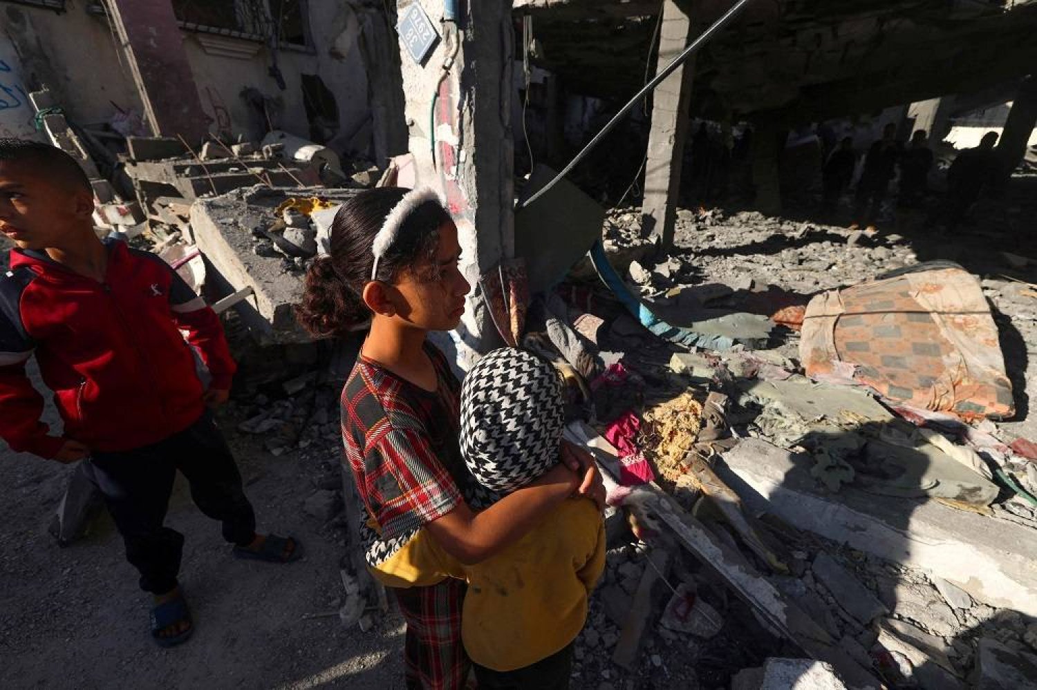 Palestinian children check a building destroyed by Israeli bombardment the previous night in Rafah the southern Gaza Strip on April 17, 2024, amid the ongoing conflict between Israel and Hamas. (AFP)