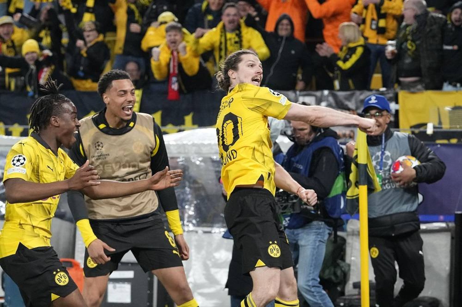 Dortmund's Marcel Sabitzer, right, celebrates in front of supporters after scoring the decisive goal during the Champions League quarterfinal second leg soccer match between Borussia Dortmund and Atlético Madrid at the Signal-Iduna Park in Dortmund, Germany, Tuesday, April 16, 2024. (AP)