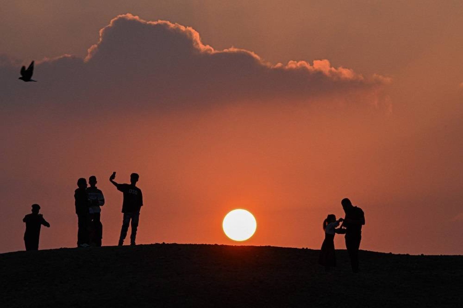 Muslims arrive at a field during sunrise to offer special morning prayers to start the Eid al-Fitr festival, which marks the end of the holy fasting month of Ramadan in Abu Sir on April 10, 2024. (AFP)