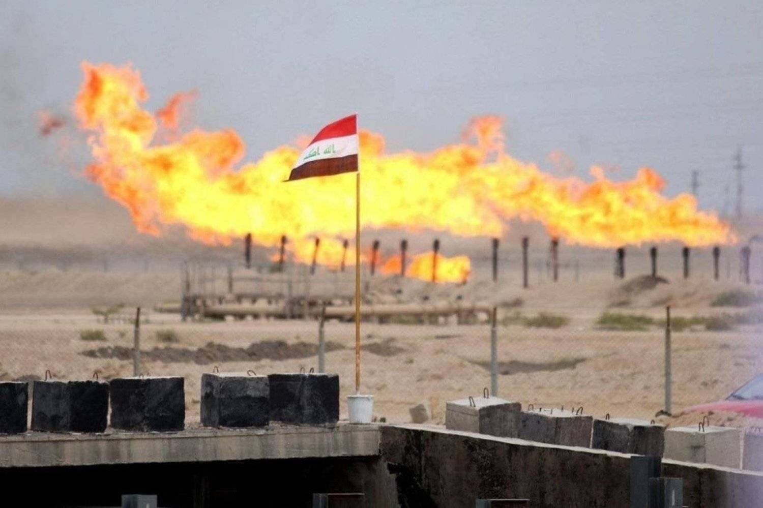 The Iraqi flag flutters in front of a gas field. (AFP) 