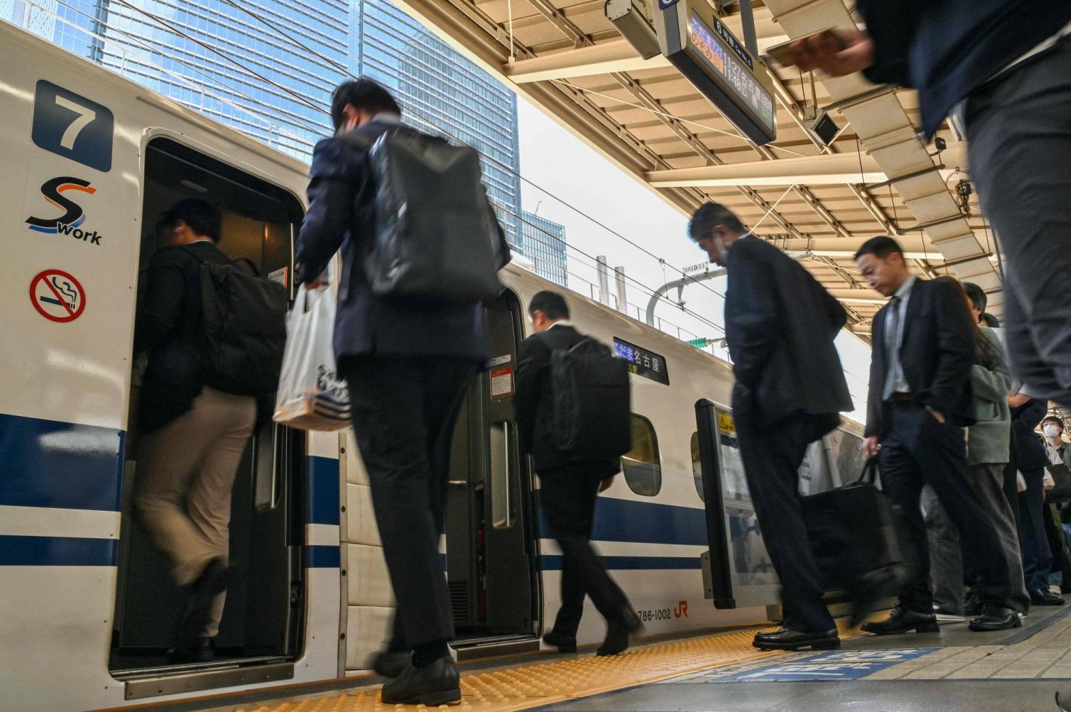 Passengers get on a Kodama bullet train, or "shinkansen" service to the city of Nagoya at Tokyo station in central Tokyo on April 17, 2024. (Photo by Richard A. Brooks / AFP)