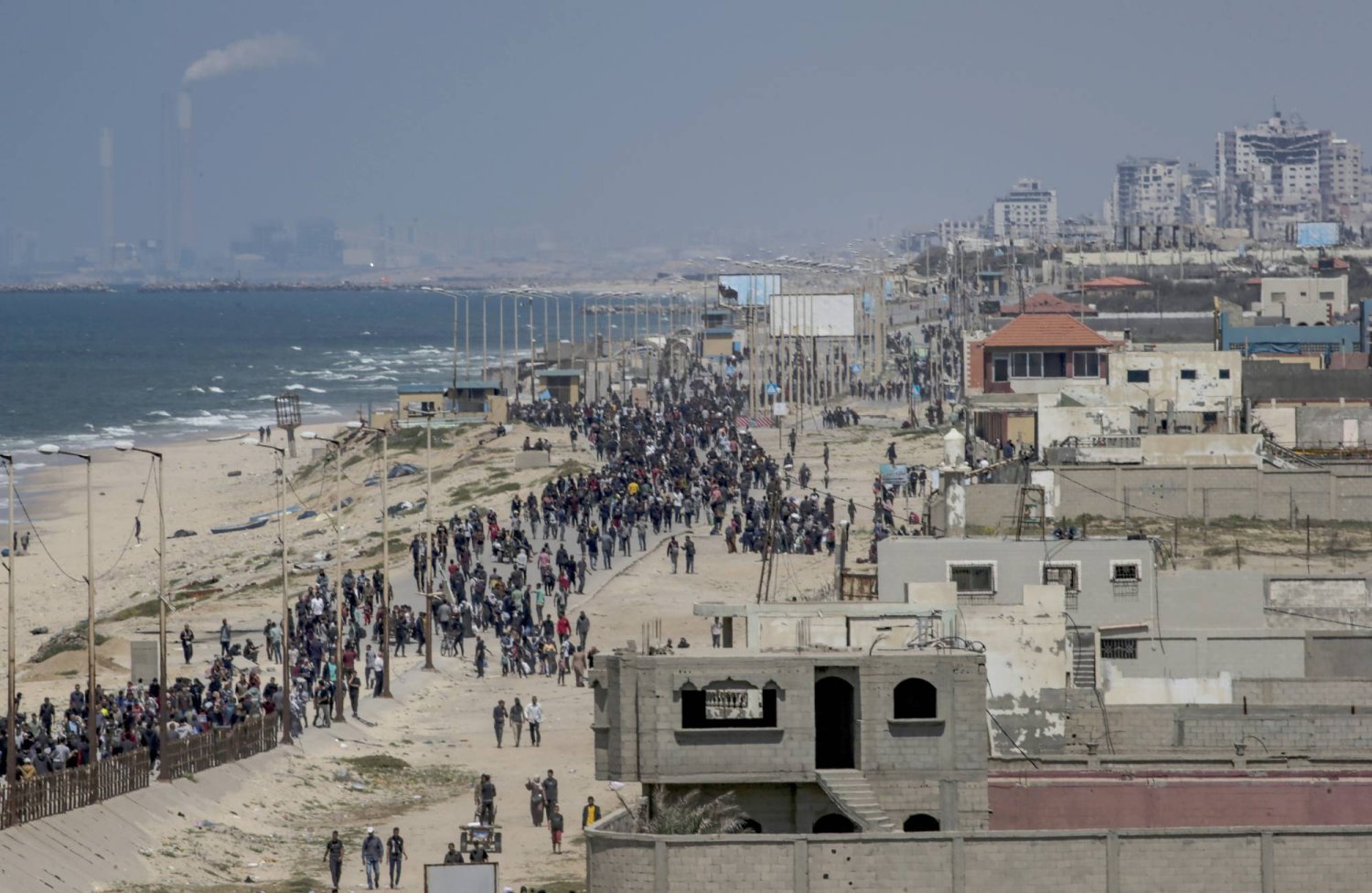 Internally displaced Palestinians who fled from the northern Gaza strip walk along Al Rashid road as they attempt to return from the southern Gaza strip, 14 April 2024. EPA/MOHAMMED SABER