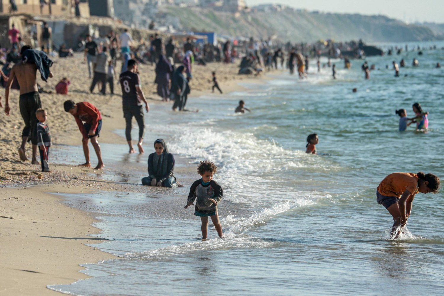 Palestinians enjoy the beach in Deir el-Balah in the central Gaza Strip on April 17, 2024, amid the ongoing conflict between Israel and Hamas. (Photo by AFP)