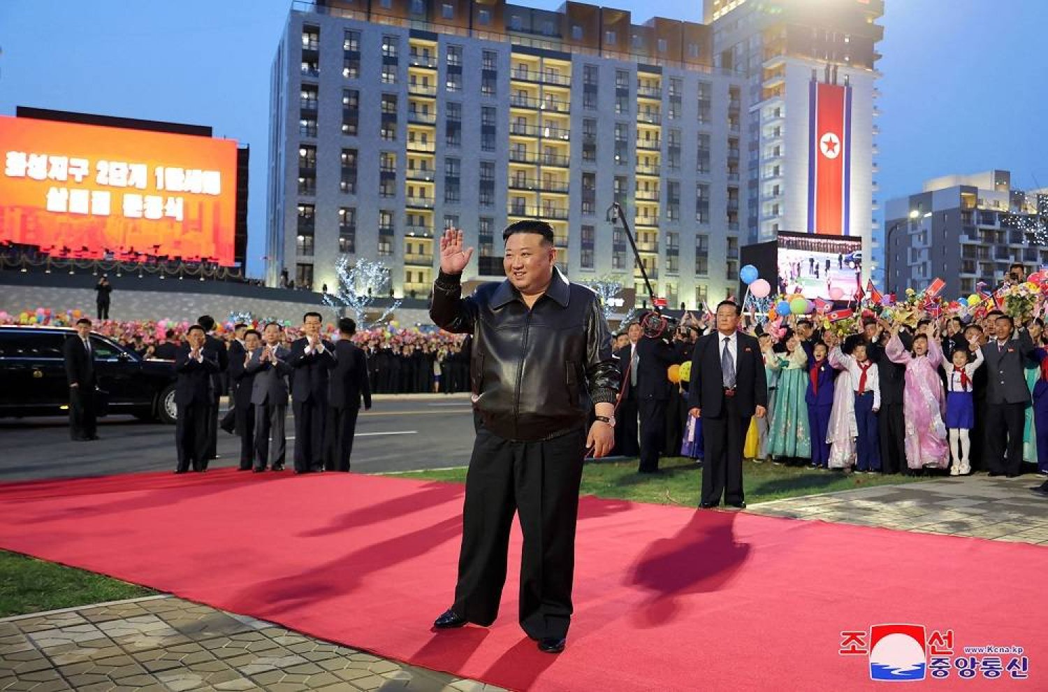 This picture taken on April 16, 2024 and released from North Korea's official Korean Central News Agency (KCNA) via KNS on April 17, 2024 shows North Korea's leader Kim Jong Un (C) taking part in a ceremony to mark the completion of the second phase of a 10,000-unit housing development in Pyongyang. (Photo by KCNA VIA KNS / AFP) 