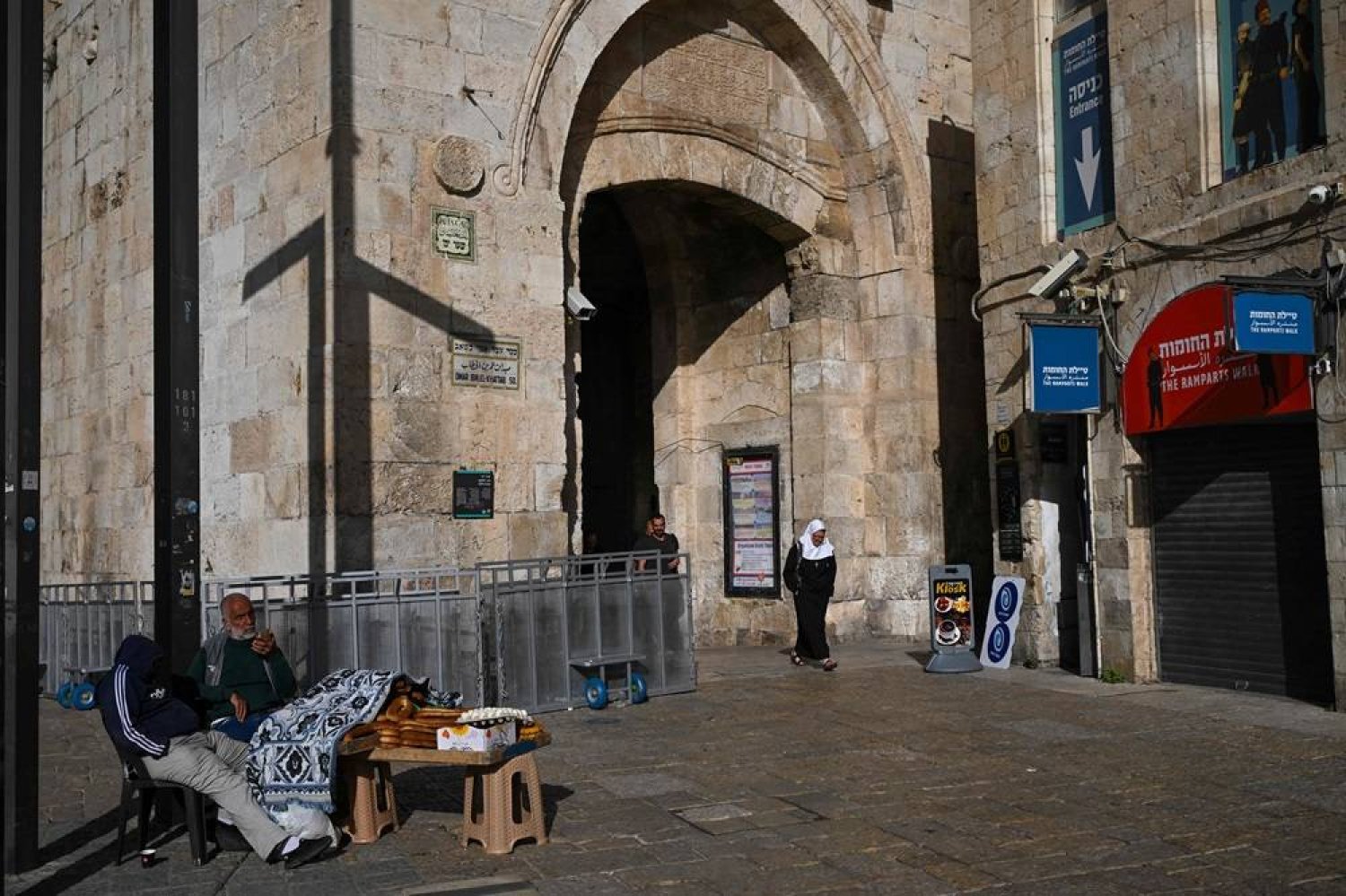 Vendors selling bread wait for customers at the Jaffa Gate in the Old City of Jerusalem on April 19, 2024. (AFP)