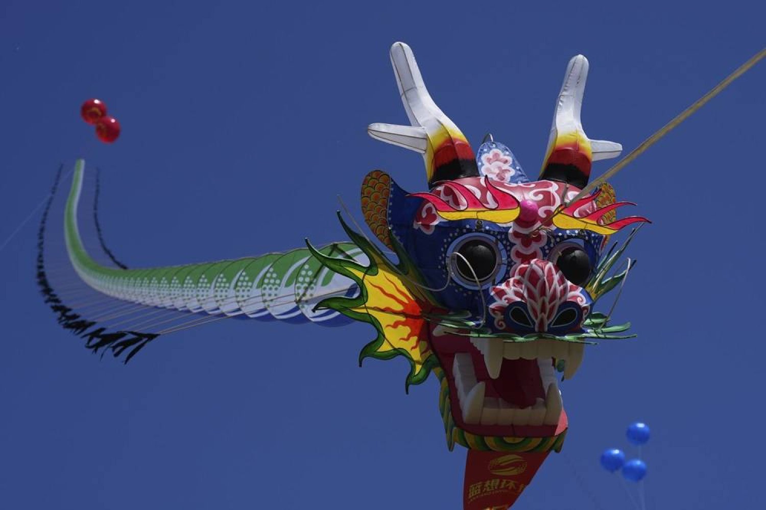  A dragon-shaped kite flies in the air at the 41st International Kite Festival in Weifang, Shandong Province of China, Saturday, April 20, 2024. (AP)