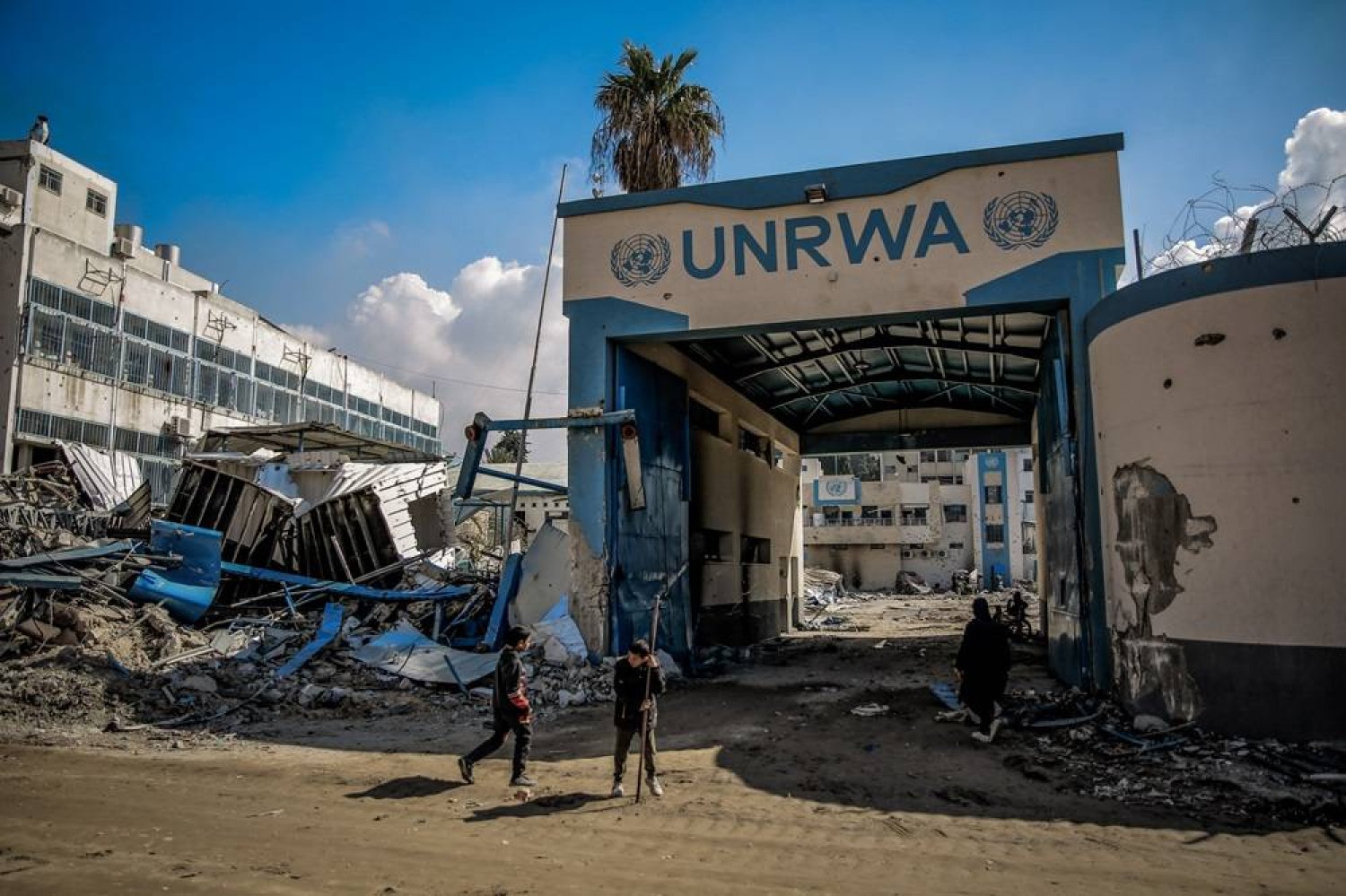 10 February 2024, Palestinian Territories, Gaza City: Palestinians examine the damage to the United Nations Relief and Works Agency for Palestine Refugees (UNRWA) buildings on their way back to their homes in the wake of the Israeli army withdrew from North of Gaza City. (dpa)