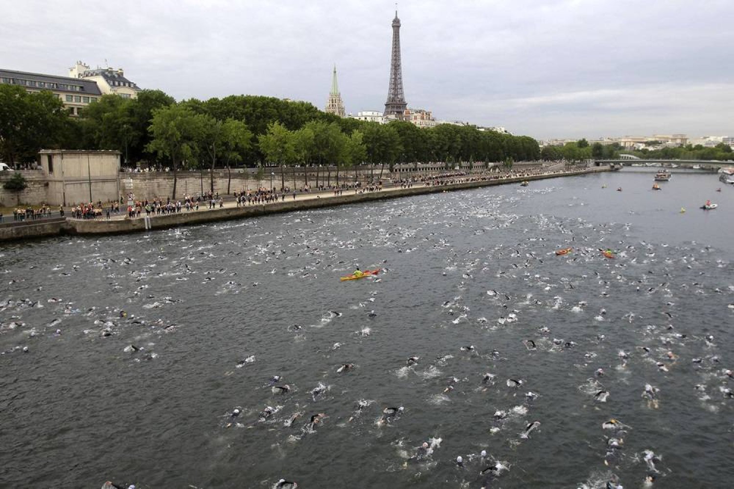 Competitors swim in the Seine River during the Paris Triathlon competition in Paris Sunday, July 10, 2011. (AP) 