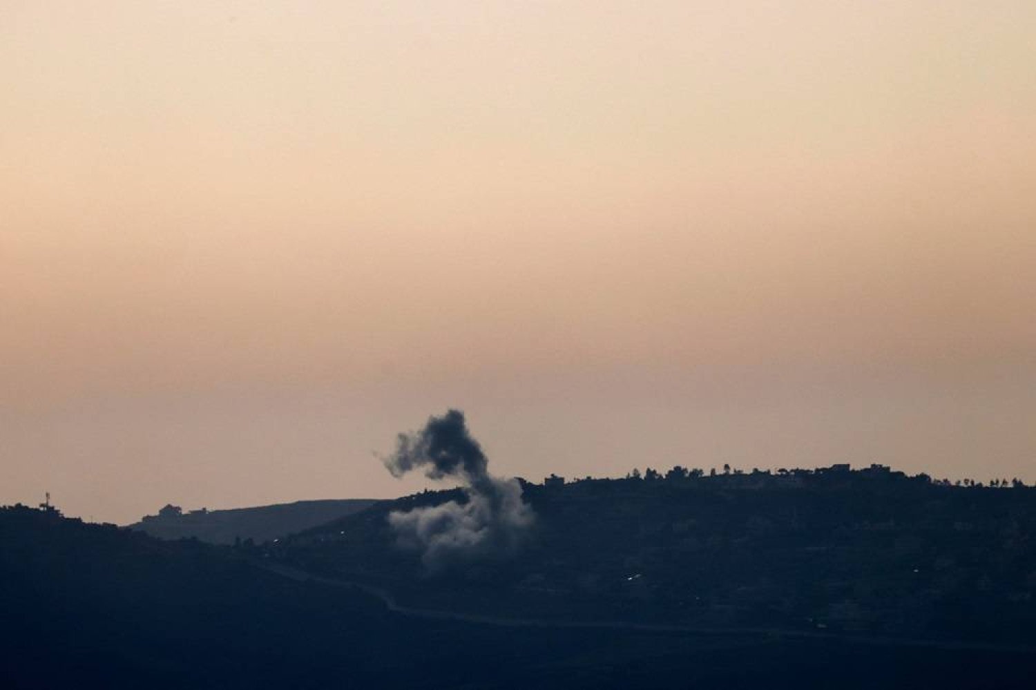 This picture taken from an Israeli position along the border with southern Lebanon shows smoke billowing above the Lebanese village of Odaisseh during Israeli bombardment on April 22, 2024, amid ongoing cross-border tensions as fighting continues between Israel and Hamas in Gaza. (AFP)