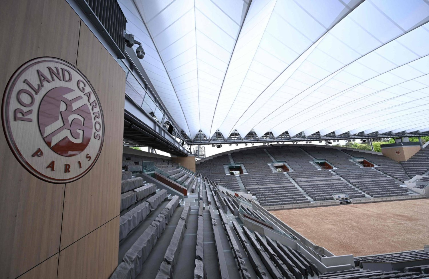 This photograph taken on April 25, 2024, shows a view of the Court Suzanne-Lenglen with its new retractable roof and a Roland Garros Paris logo after a press conference presenting the 2024 edition of the Roland Garros Grand Slam tennis tournament, at the Roland Garros stadium complex in Paris. (Photo by Bertrand GUAY / AFP)