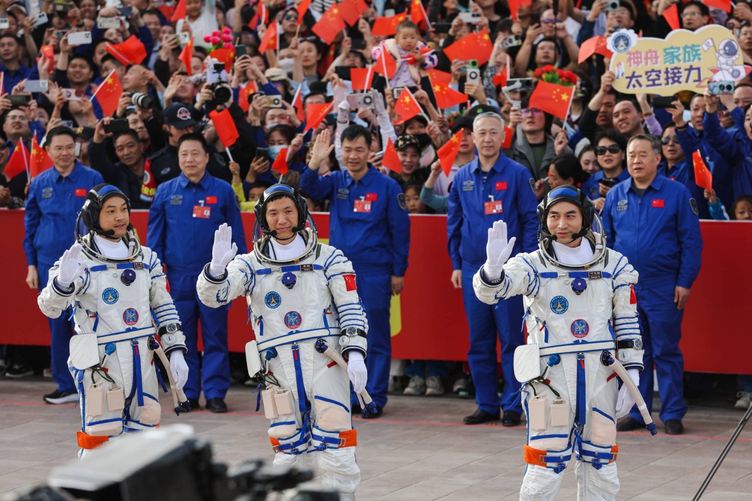 Shenzhou-18 manned spaceflight mission astronauts commander Ye Guangfu (R), Li Cong (C), and Li Guangsu wave during the see-off ceremony before the launch in Jiuquan, Gansu province, China, 25 April 2024. EPA/WU HAO
