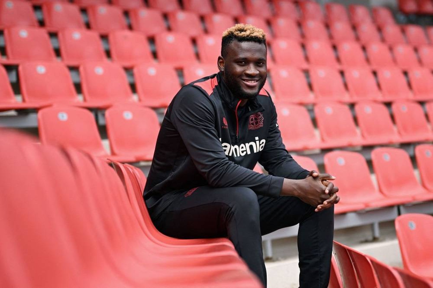 Bayer Leverkusen's Nigerian forward #22 Victor Boniface sits after an interview with AFP at the BayArena in Leverkusen, western Germany, on April 24, 2024. (AFP)
