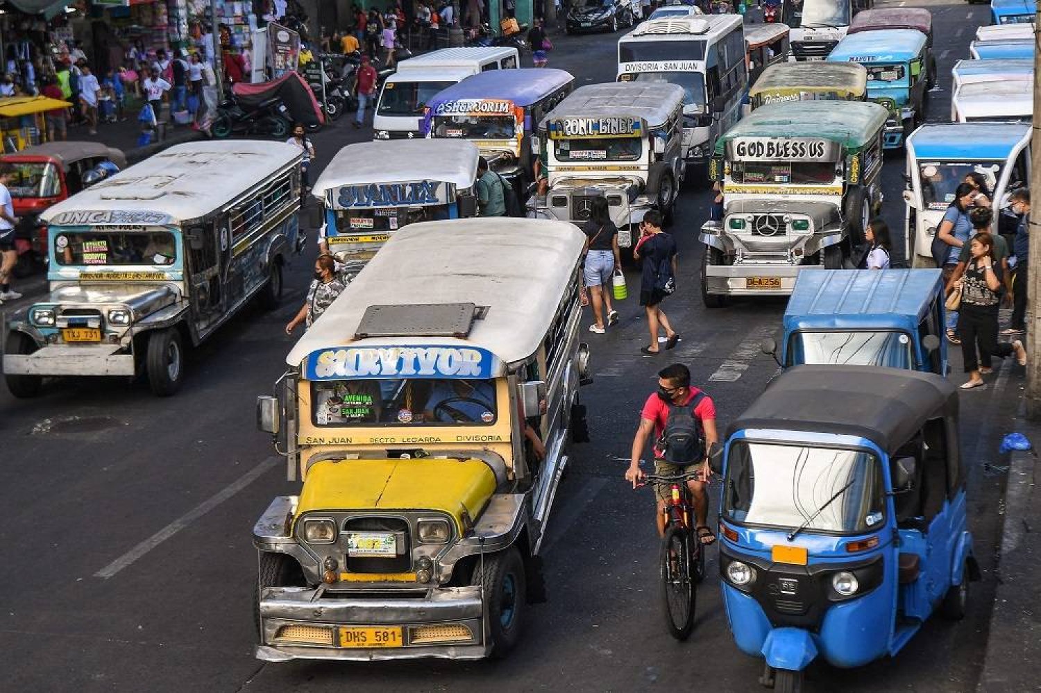 In this photo taken on April 5, 2024, jeepneys commute along a street in Manila. (AFP)