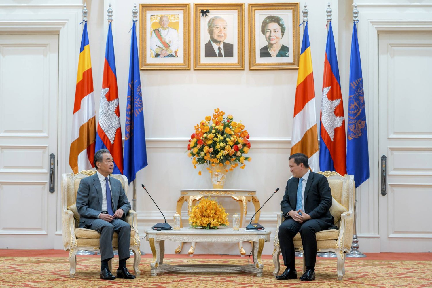 In this photo released by Agence Kampuchea Press (AKP), Chinese Foreign Minister Wang Yi, left, holds talk with Cambodian Prime Minister Hun Manet, right, in Peace Palace, in Phnom Penh, Cambodia, Monday, April 22, 2024. (AKP via AP)