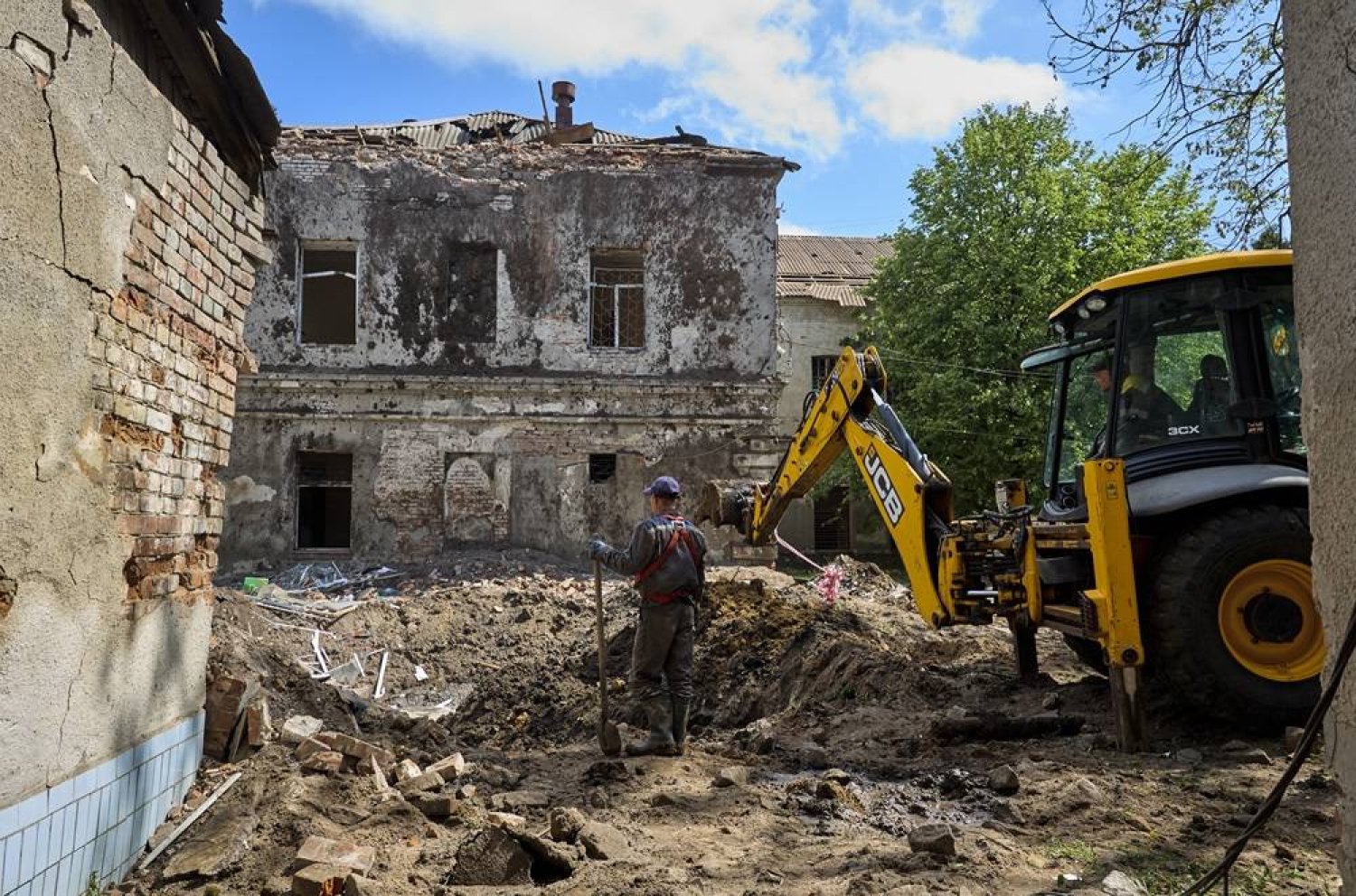 Communal workers operate at the site of a rocket attack on a regional psychiatric hospital in Kharkiv, northeastern Ukraine, 27 April 2024. (EPA)
