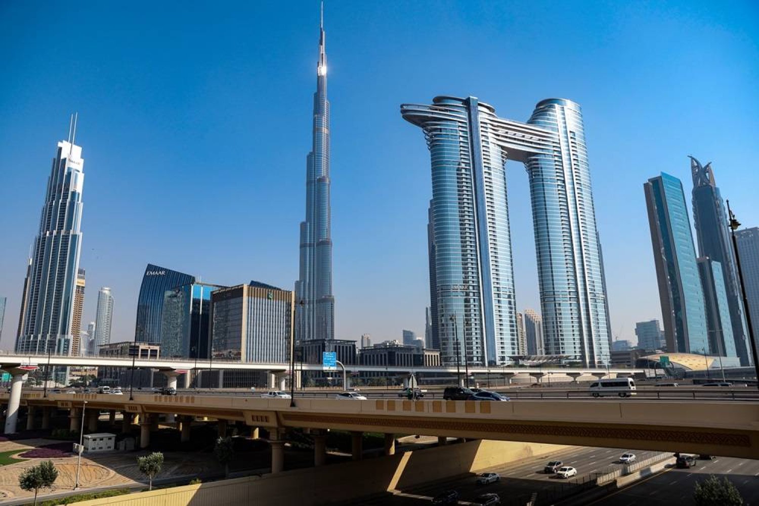 Vehicles drive on Sheikh Zayed road after it was cleaned from flood water, backdropped by the world's tallest building of Burj Khalifa in Dubai, United Arab Emirates, 19 April 2024. (EPA)
