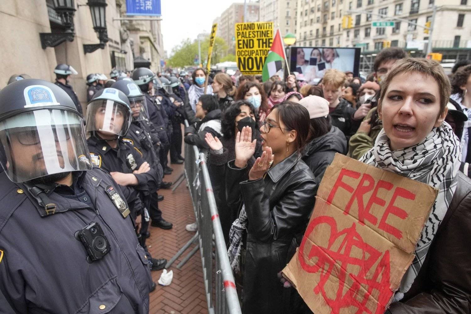 FILE - Police in Riot gear stand guard as demonstrators chant slogans outside the Columbia University campus, Thursday, April 18, 2024, in New York. (AP Photo/Mary Altaffer, File)
