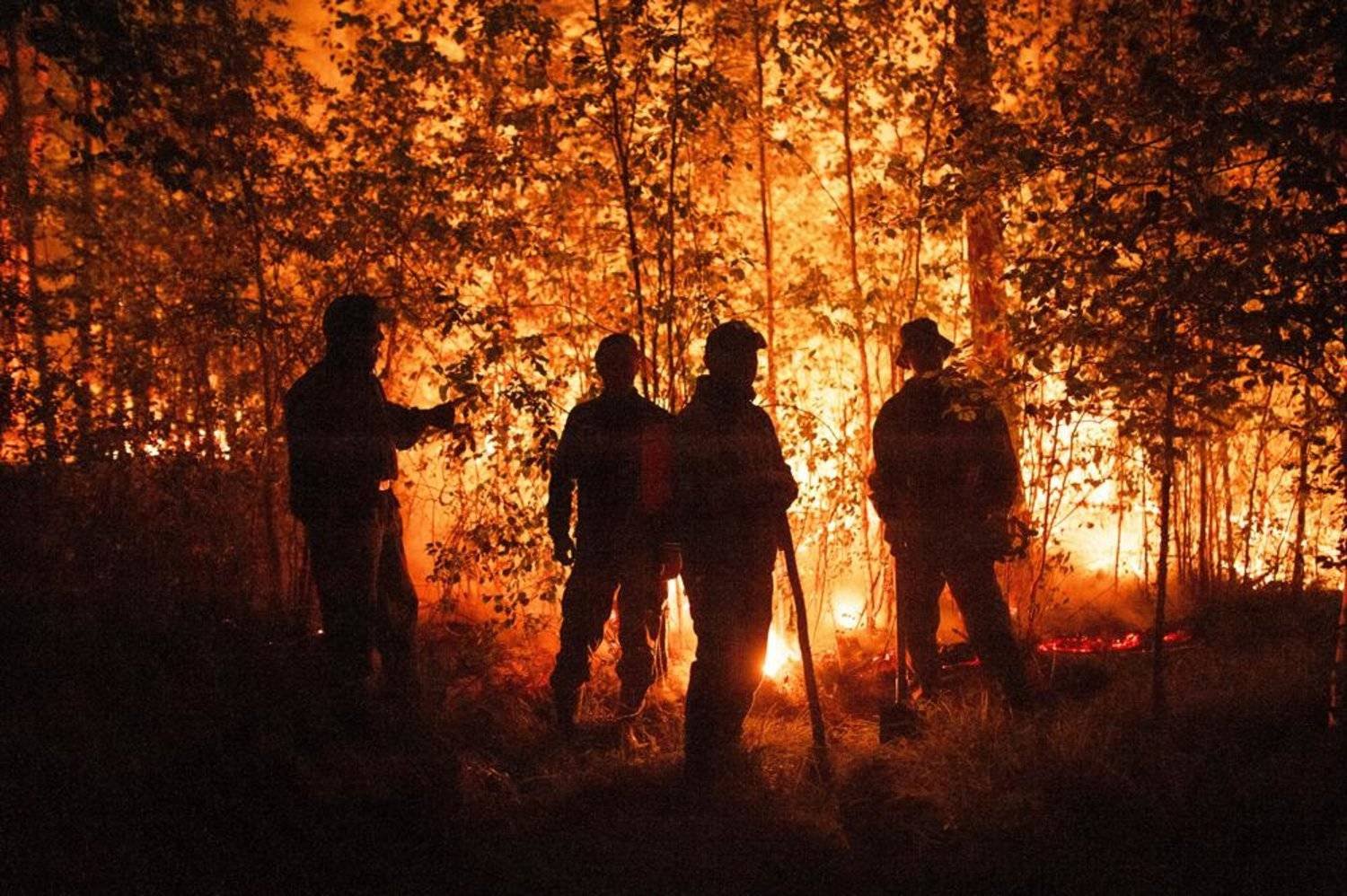 File Photo: Firefighters work at the scene of forest fire near Kyuyorelyakh village at Gorny Ulus area, west of Yakutsk, in Russia Thursday, Aug. 5, 2021. (AP)
