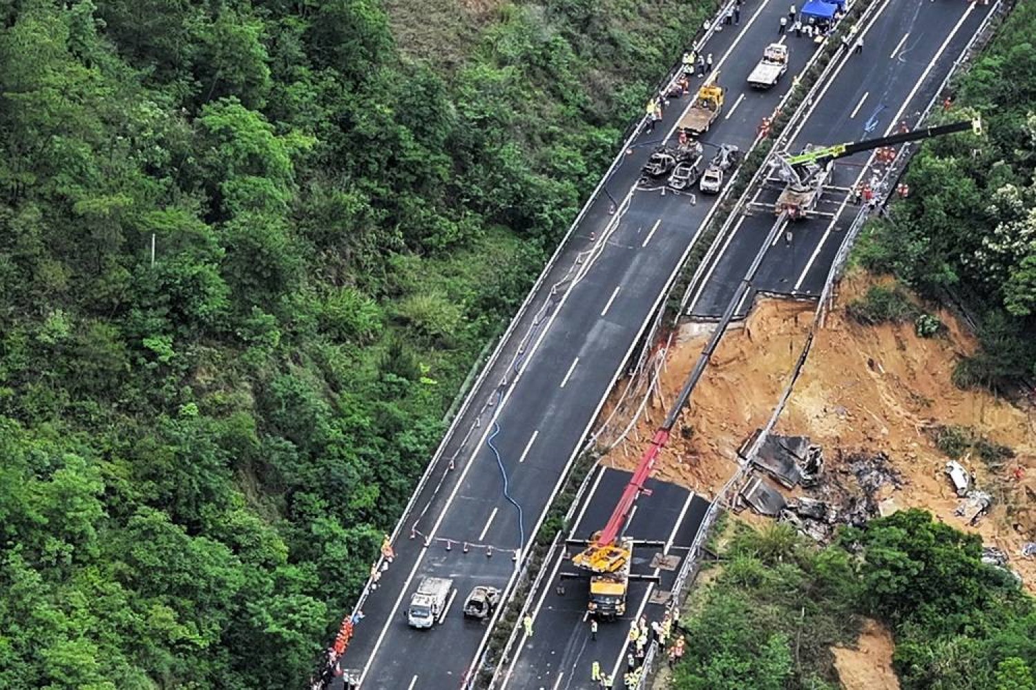  In this photo released by Xinhua News Agency, an aerial photo shows rescuers work at the site of a collapsed road section of the Meizhou-Dabu Expressway in Meizhou, south China's Guangdong Province, Wednesday, May 1, 2024. (Xinhua News Agency via AP) 