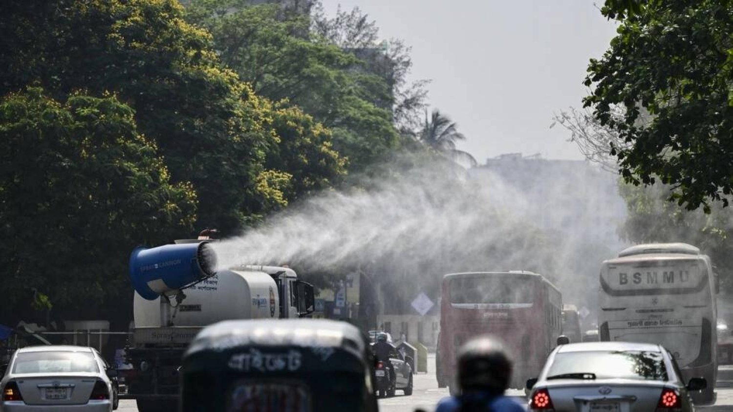 A vehicle of the Dhaka North City Corporation sprays water along a busy road to lower the temperature amidst a heatwave. MUNIR UZ ZAMAN / AFP
