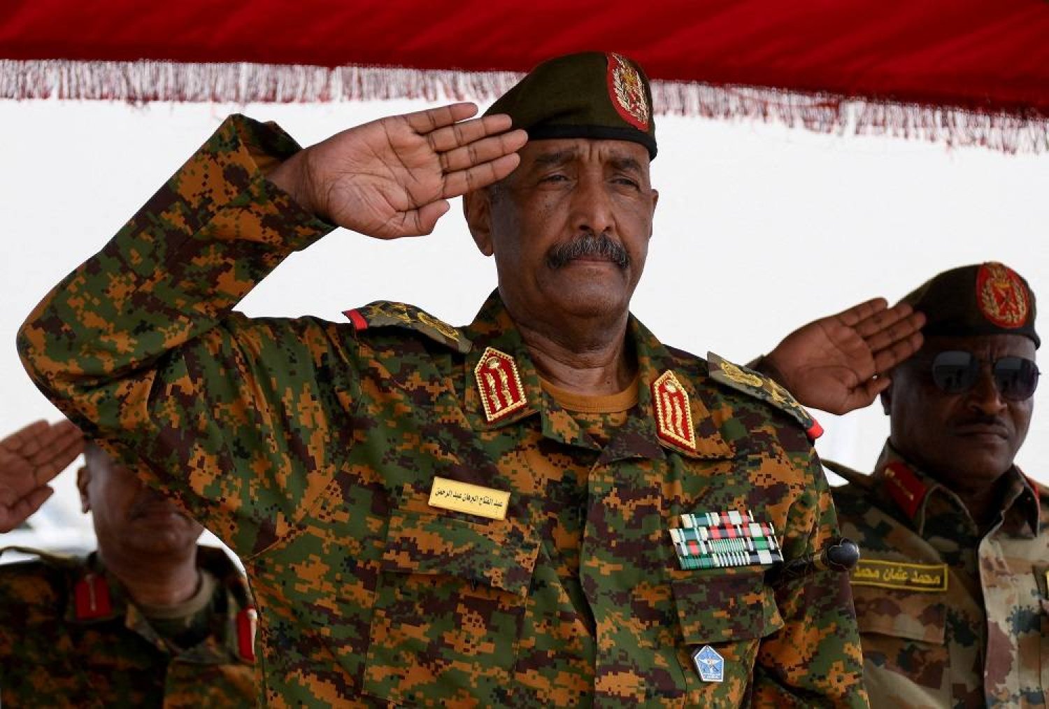 Sudan's General Abdel Fattah al-Burhan salutes as he listens to the national anthem after landing in the military airport of Port Sudan on his first trip away following the crisis in Sudan's capital Khartoum since an internal conflict broke out, in the city of Port Sudan, Sudan, August 27, 2023. (Reuters)