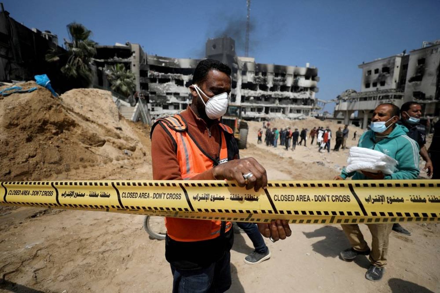 A man tapes off the area as rescuers and medics search for dead bodies inside the damaged Al Shifa Hospital after Israeli forces withdrew from the hospital and the area around it following a two-week operation, amid the ongoing conflict between Israel and Hamas, in Gaza City April 8, 2024. (Reuters)