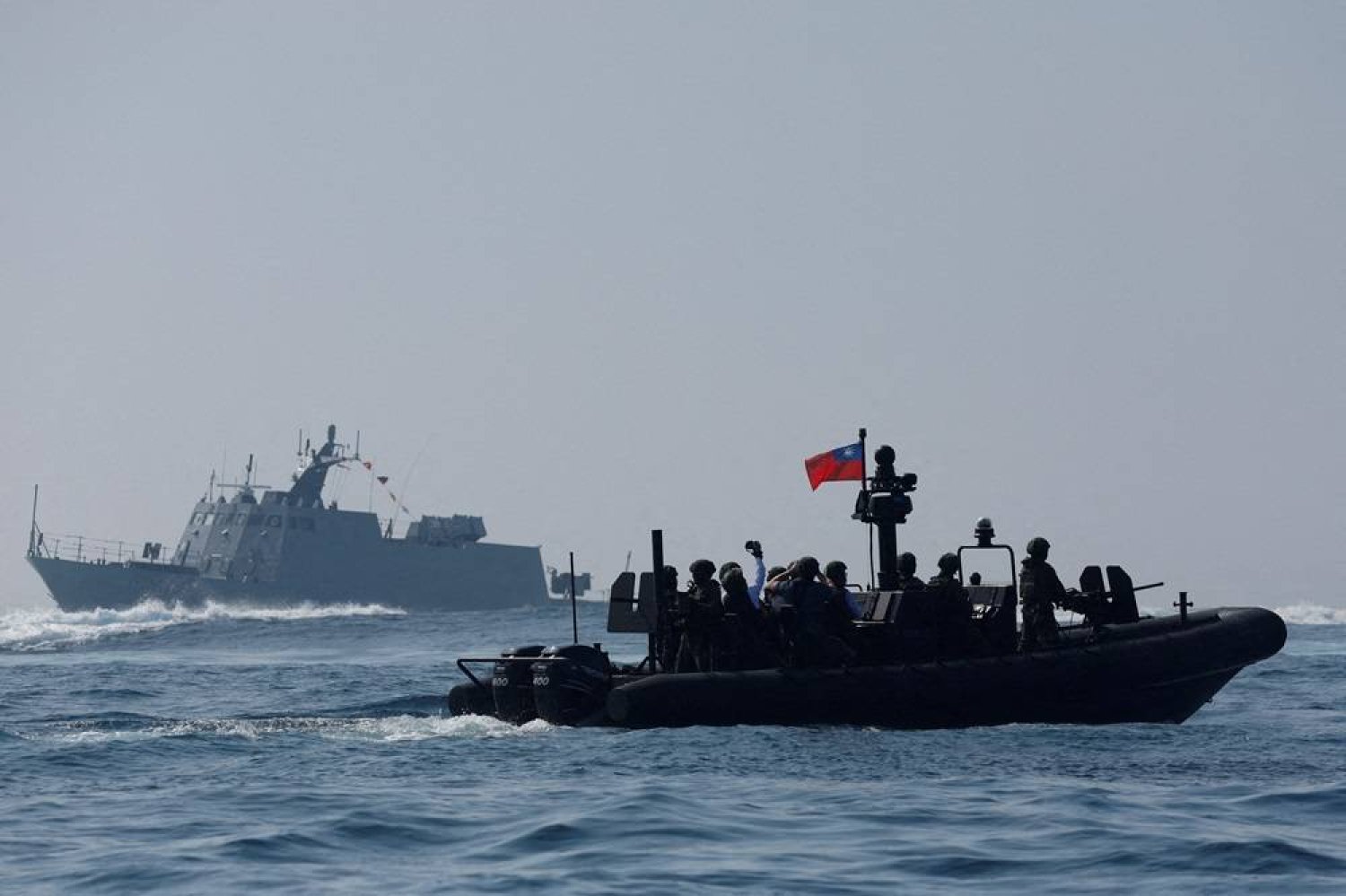  Members of Taiwan's Navy and media onboard a special operation boat navigate near a Kuang Hua VI-class missile boat, during a drill part of a demonstration for the media, to show combat readiness ahead of the Lunar New Year holidays, on the waters near a military base in Kaohsiung, Taiwan January 31, 2024. (Reuters)