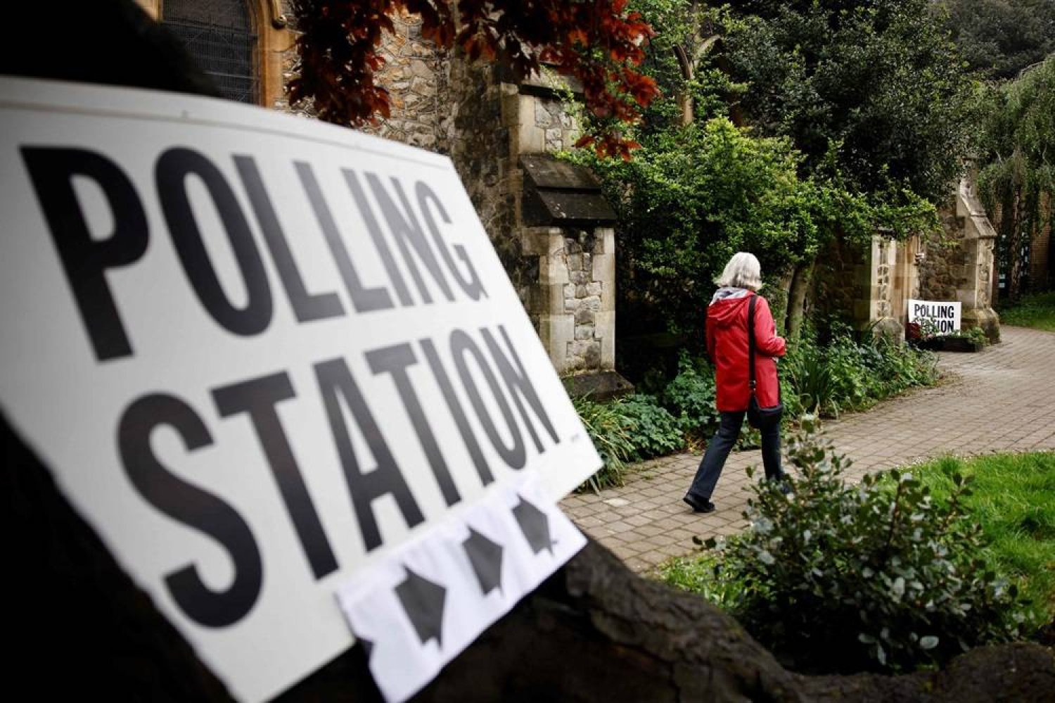 A voter arrives at a polling station located at Saint Savior Church in Chalk Farm, north London, to cast her vote in local elections, on May 2, 2024. (AFP)